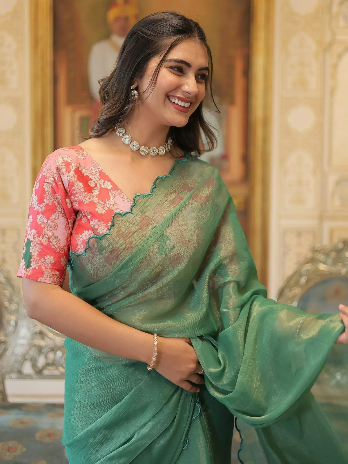 Woman in elegant green saree with pink floral blouse, perfect for Indian ethnic wear occasions