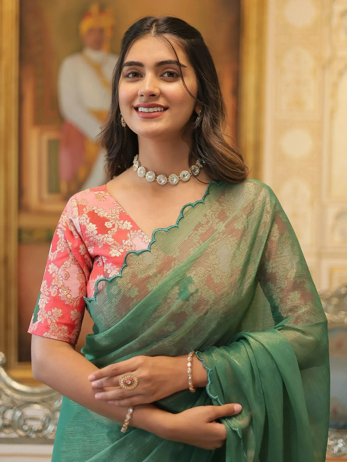 Elegant woman in green saree with pink floral blouse, perfect for Indian ethnic occasions and weddings.