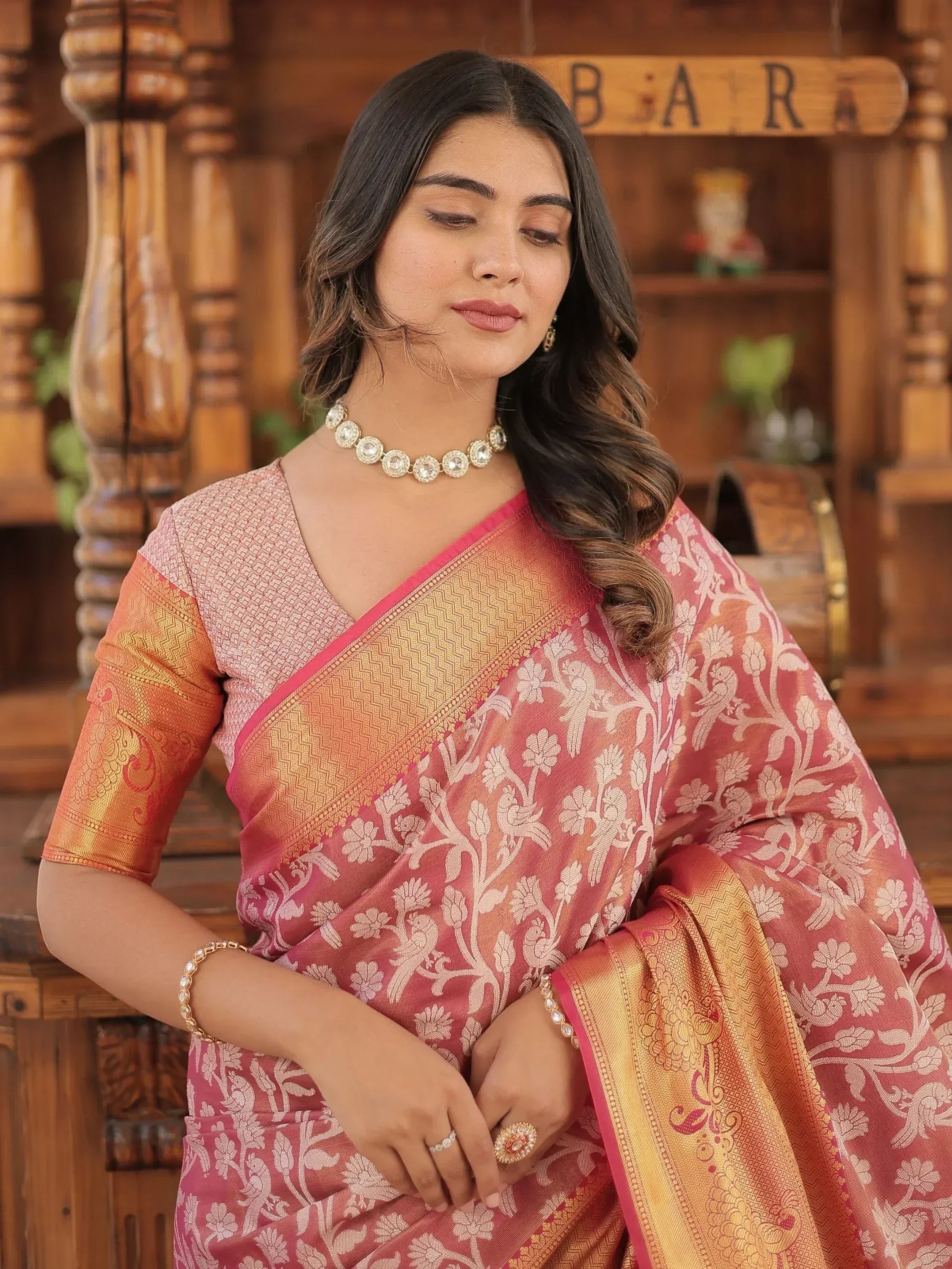 Pink and gold floral Banarasi saree with intricate woven design, perfect for Indian ethnic occasions