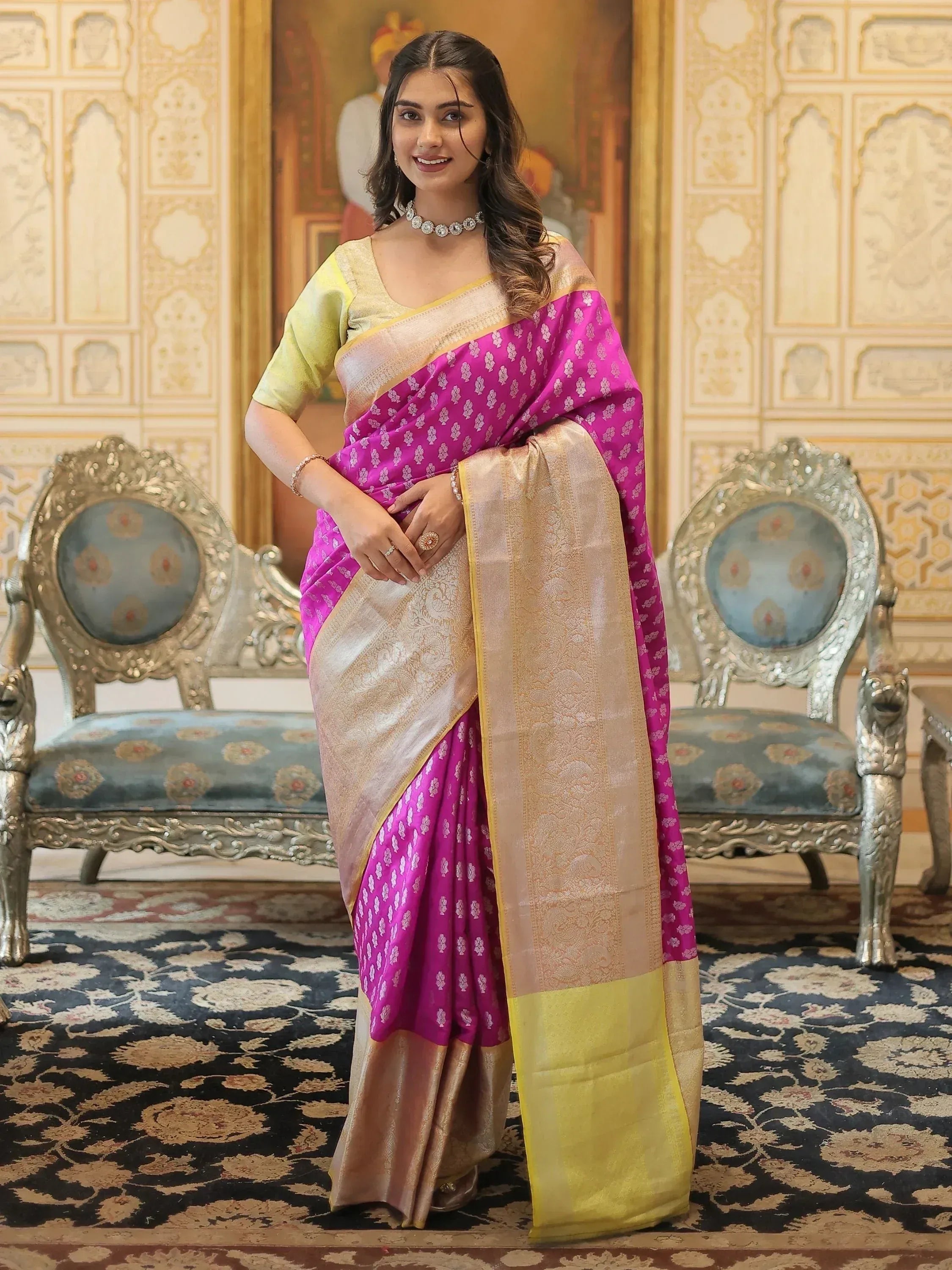 Woman in vibrant pink and gold designer saree with intricate patterns, perfect for ethnic occasions