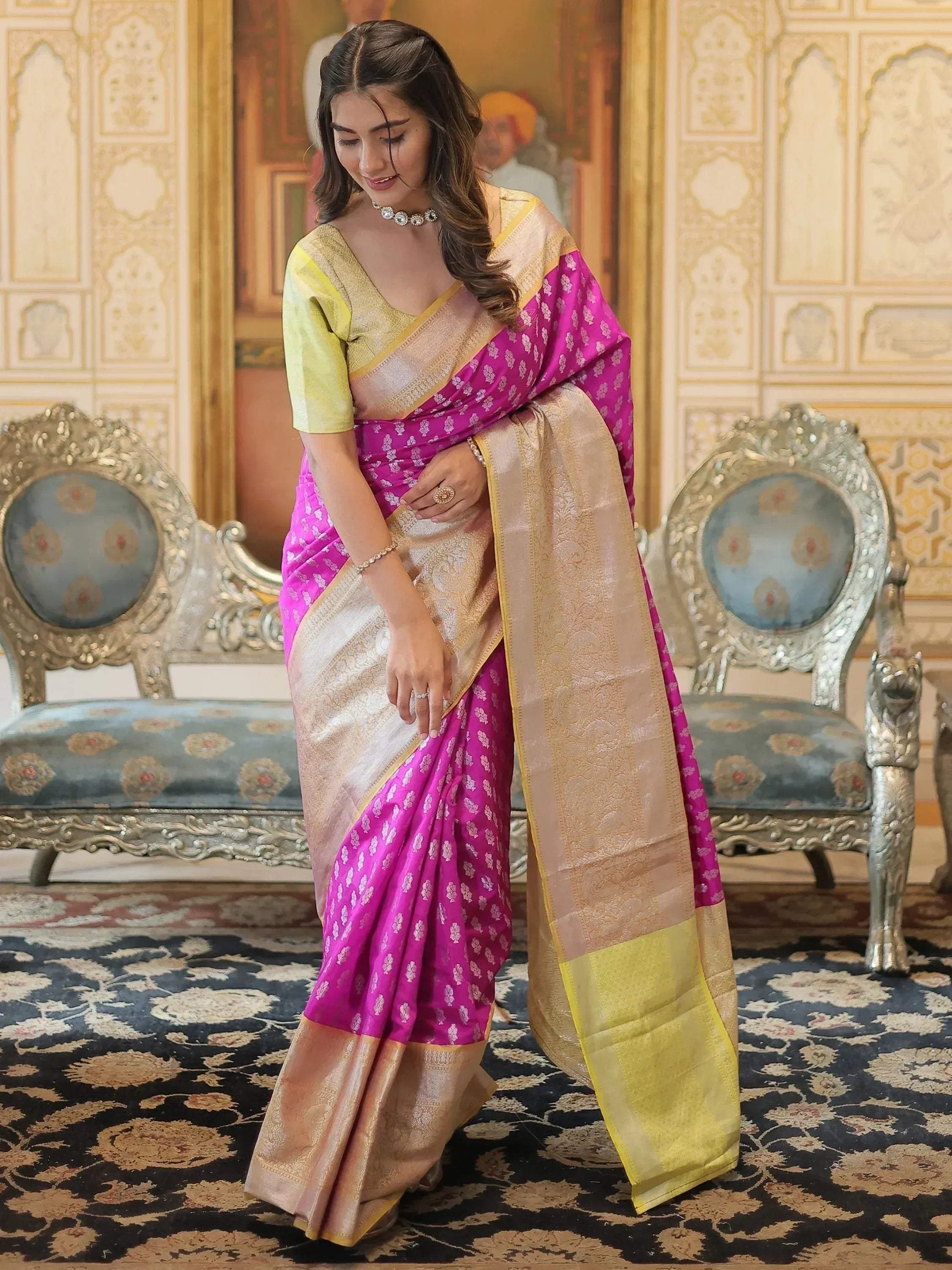 Woman in vibrant pink and gold designer saree with intricate patterns, perfect for ethnic occasions
