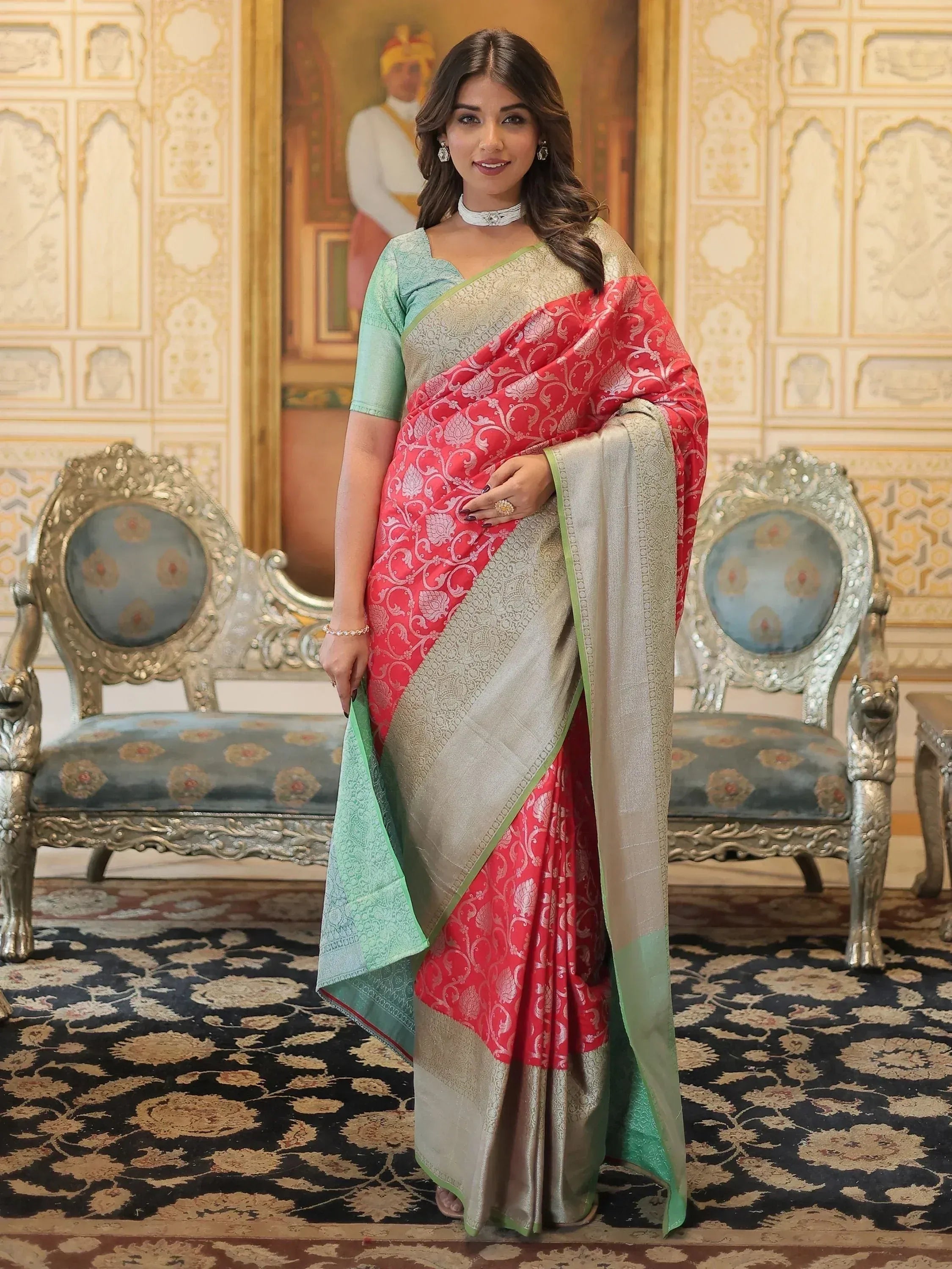 Woman in elegant red and gold designer saree with green blouse, perfect for Indian ethnic wear occasions