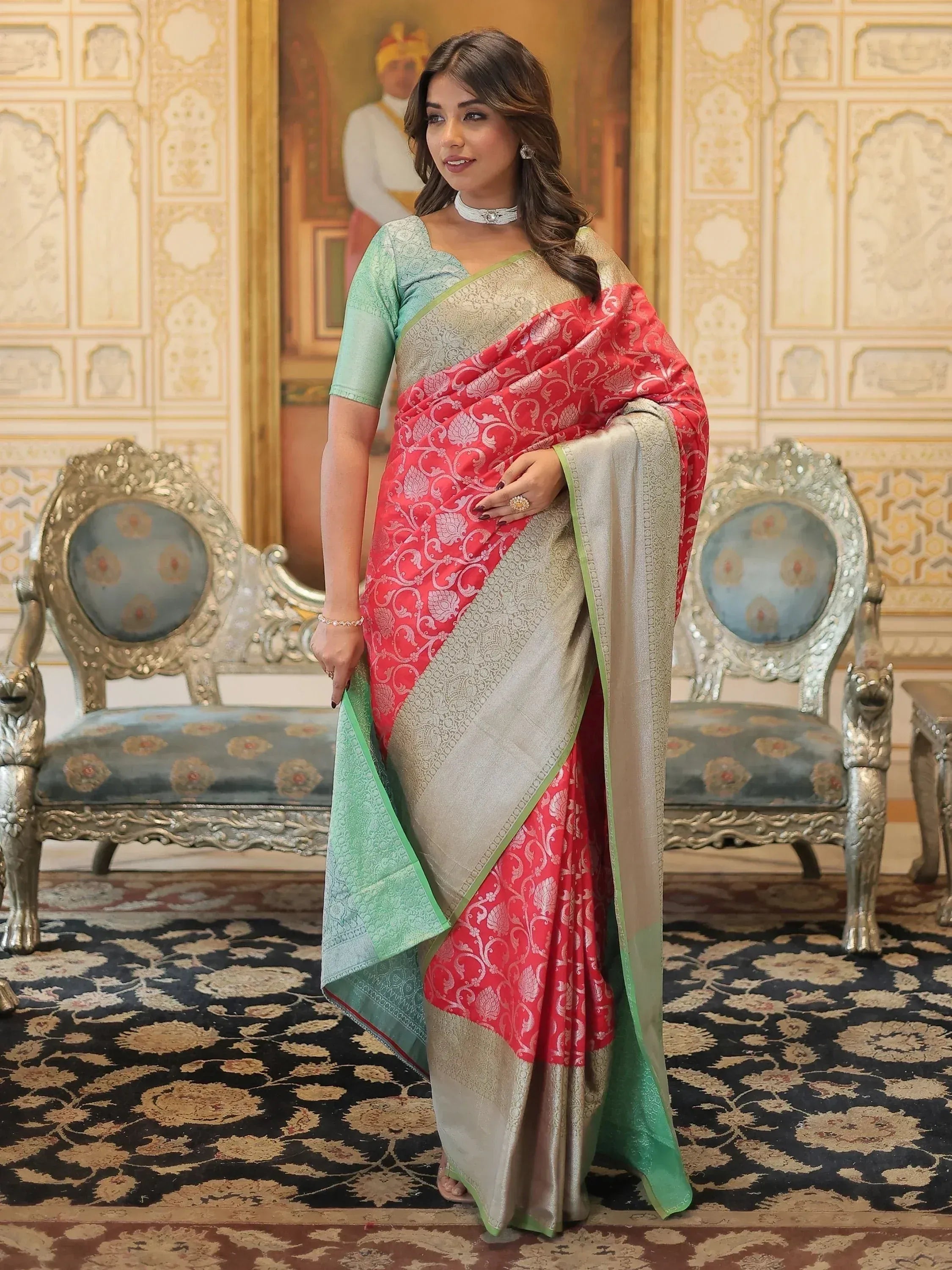 Woman in elegant red and mint green designer saree with gold embroidery, perfect for Indian ethnic occasions