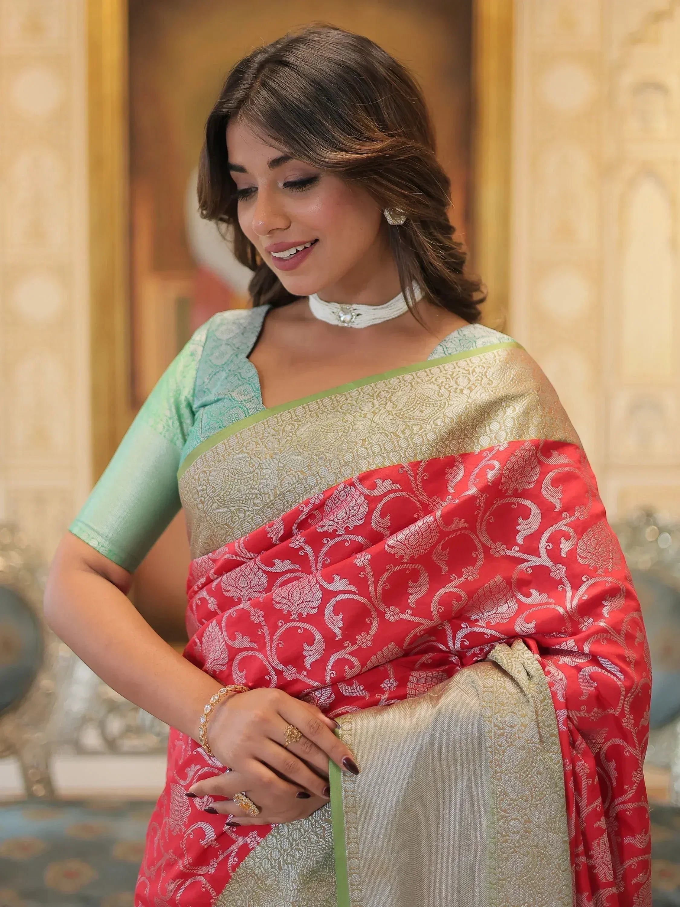 Woman in red and gold designer saree with green blouse, elegant ethnic wear for festive occasions