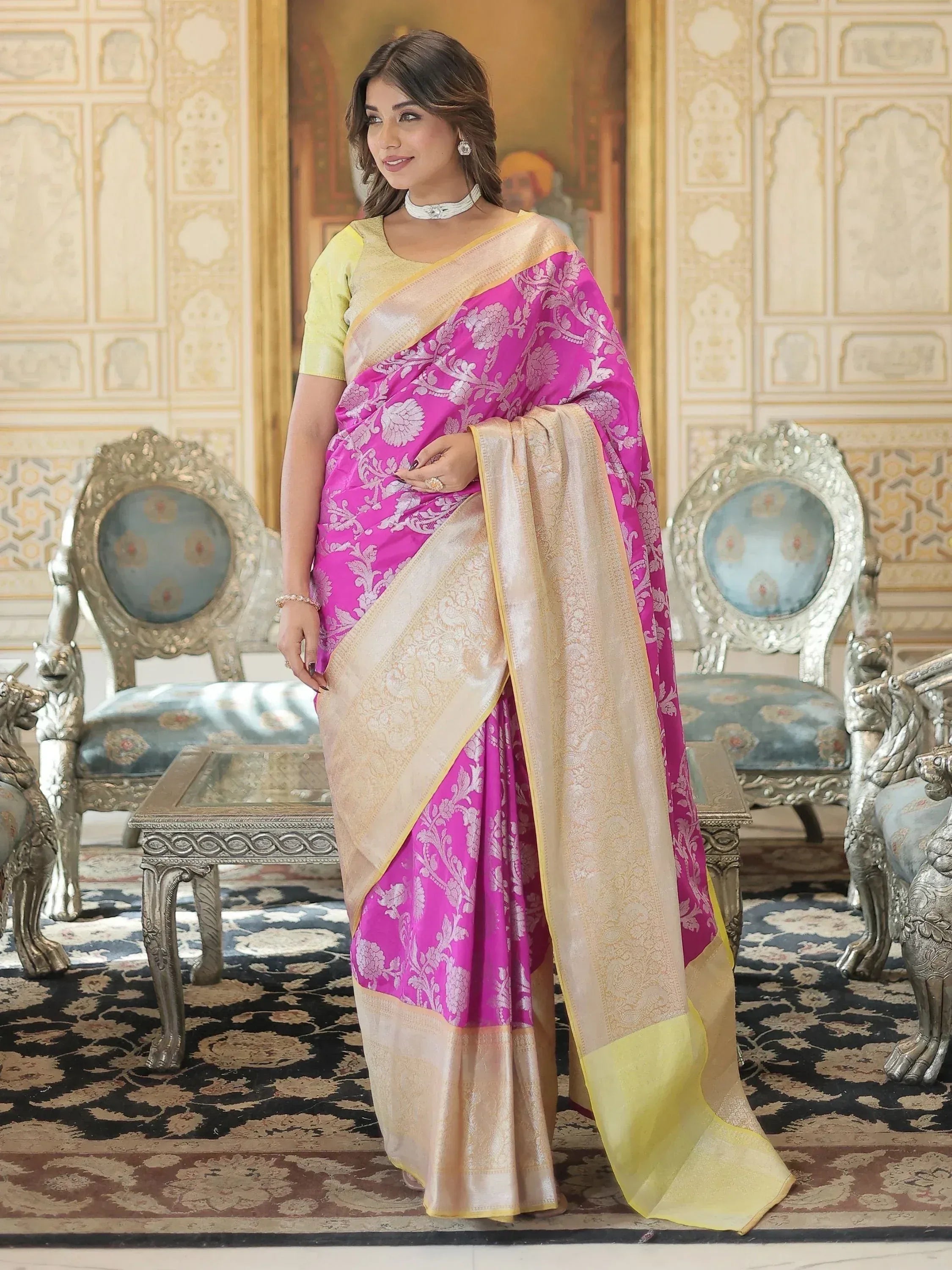 Vibrant pink floral saree with gold border, paired with yellow blouse, elegant ethnic wear for festive occasions