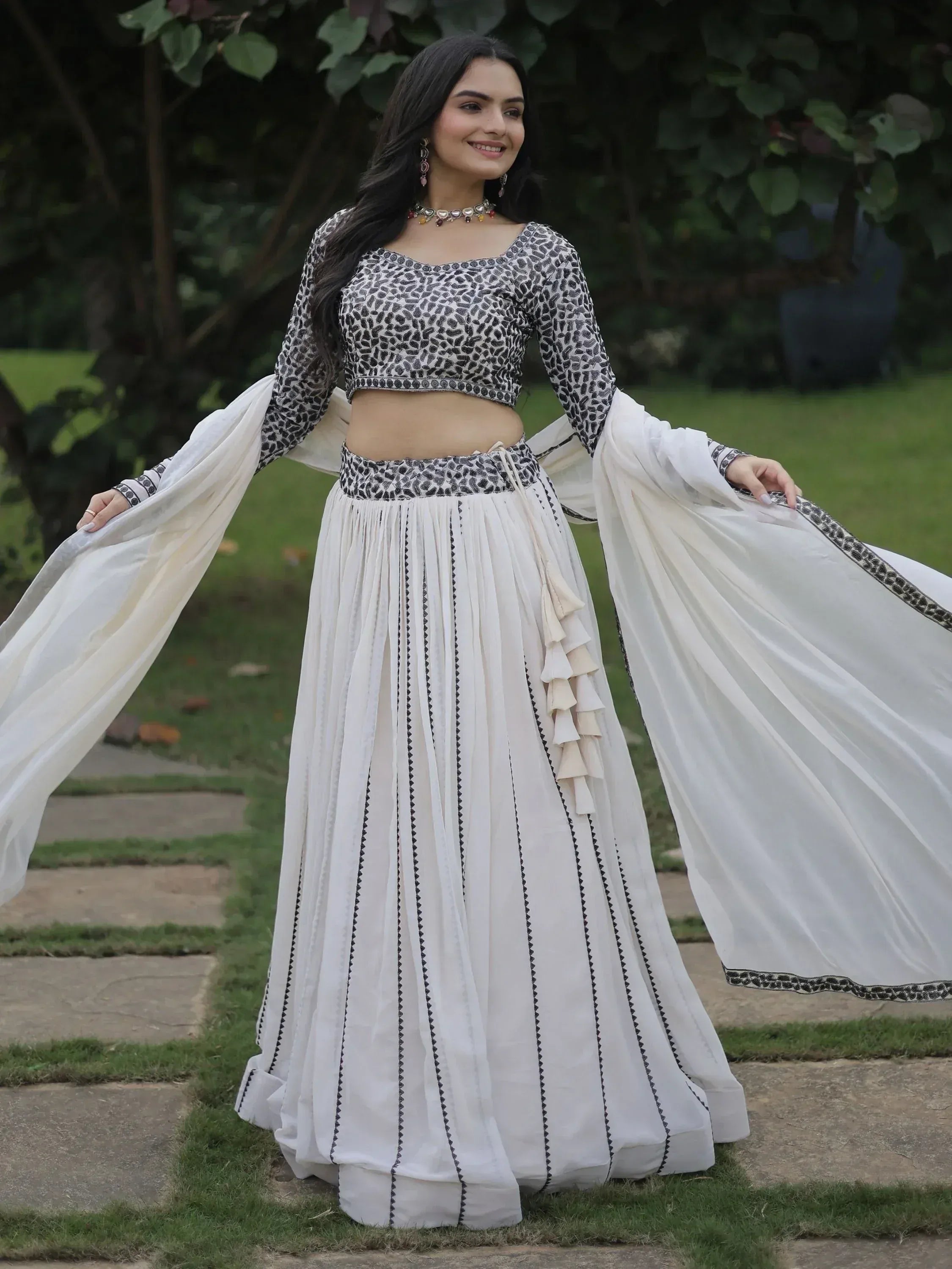 White and black printed ethnic lehenga choli with flared skirt and long sleeves, perfect for Indian occasions