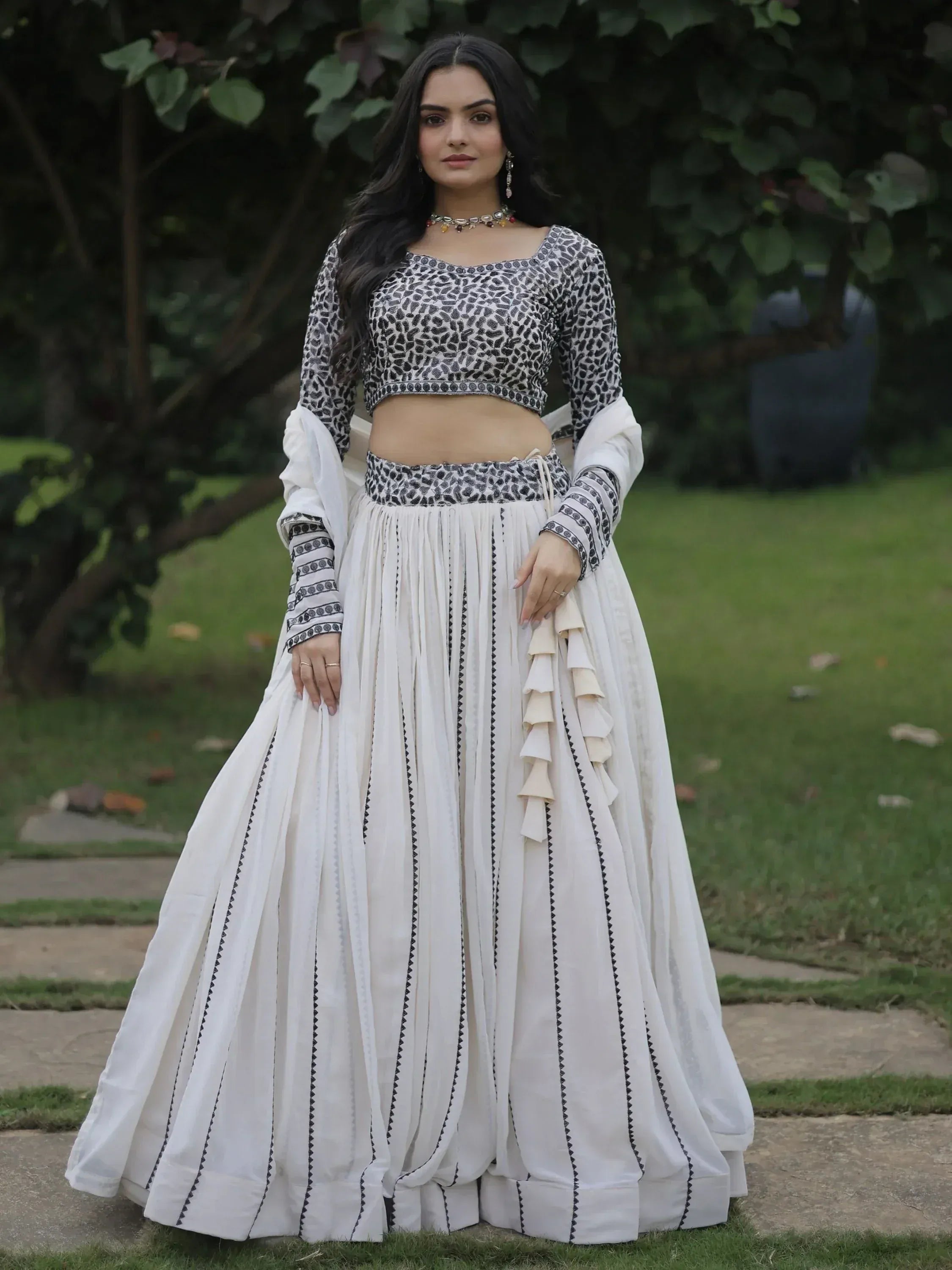White and black printed ethnic lehenga choli with ruffled skirt, perfect for Indian occasions