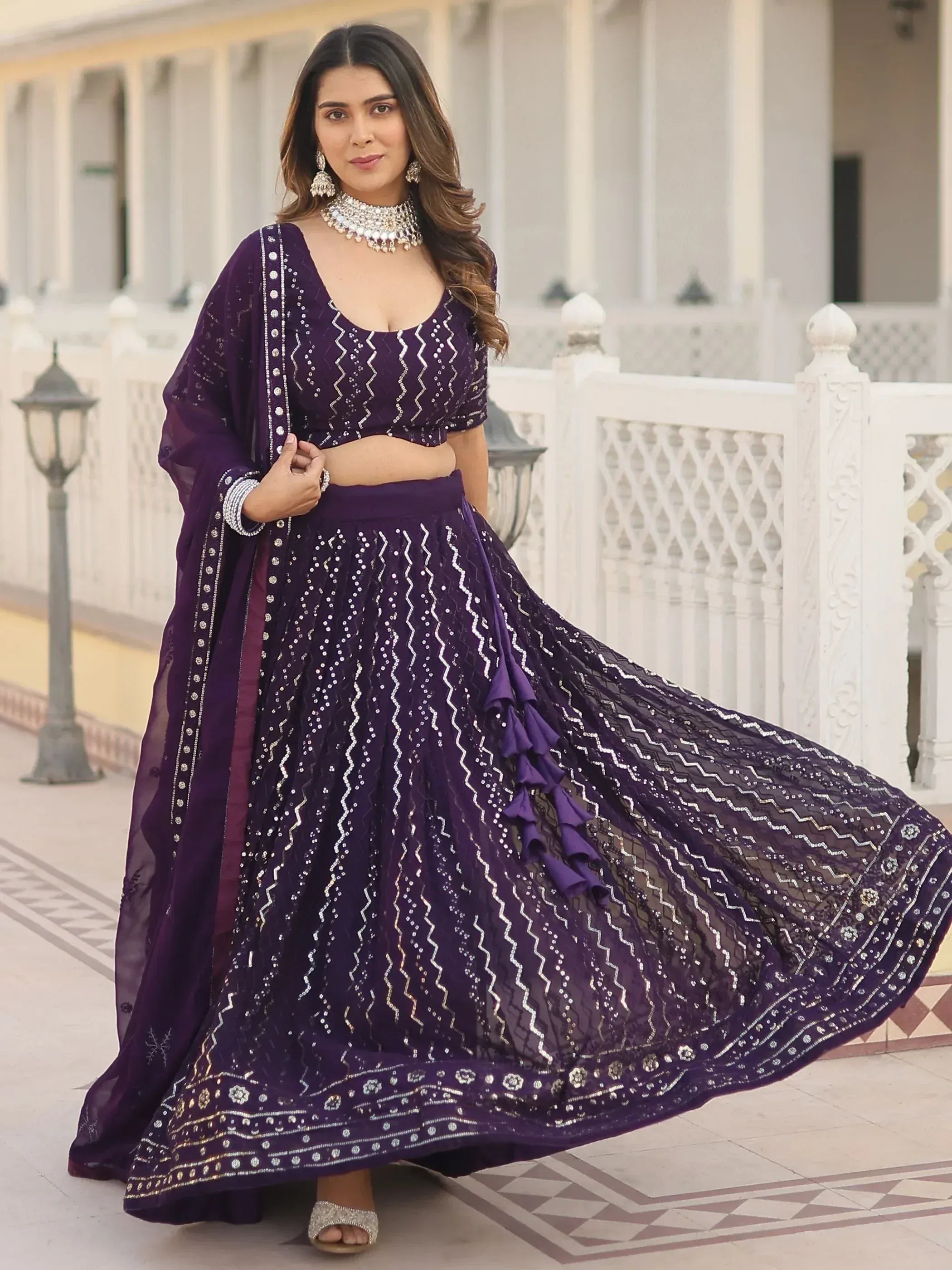 Purple embroidered lehenga choli with sequin work, perfect for Indian weddings and festive occasions.