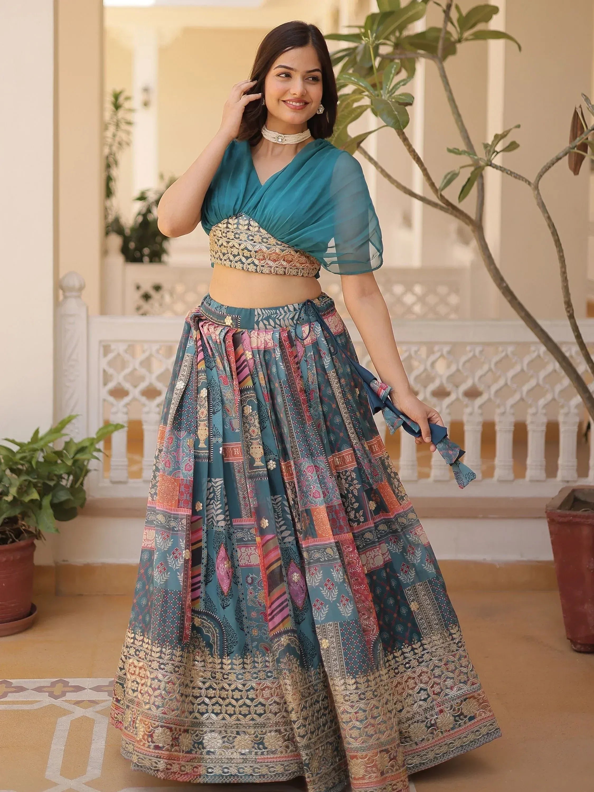 Teal printed lehenga choli with embroidered blouse, perfect for Indian ethnic wear and festive occasions