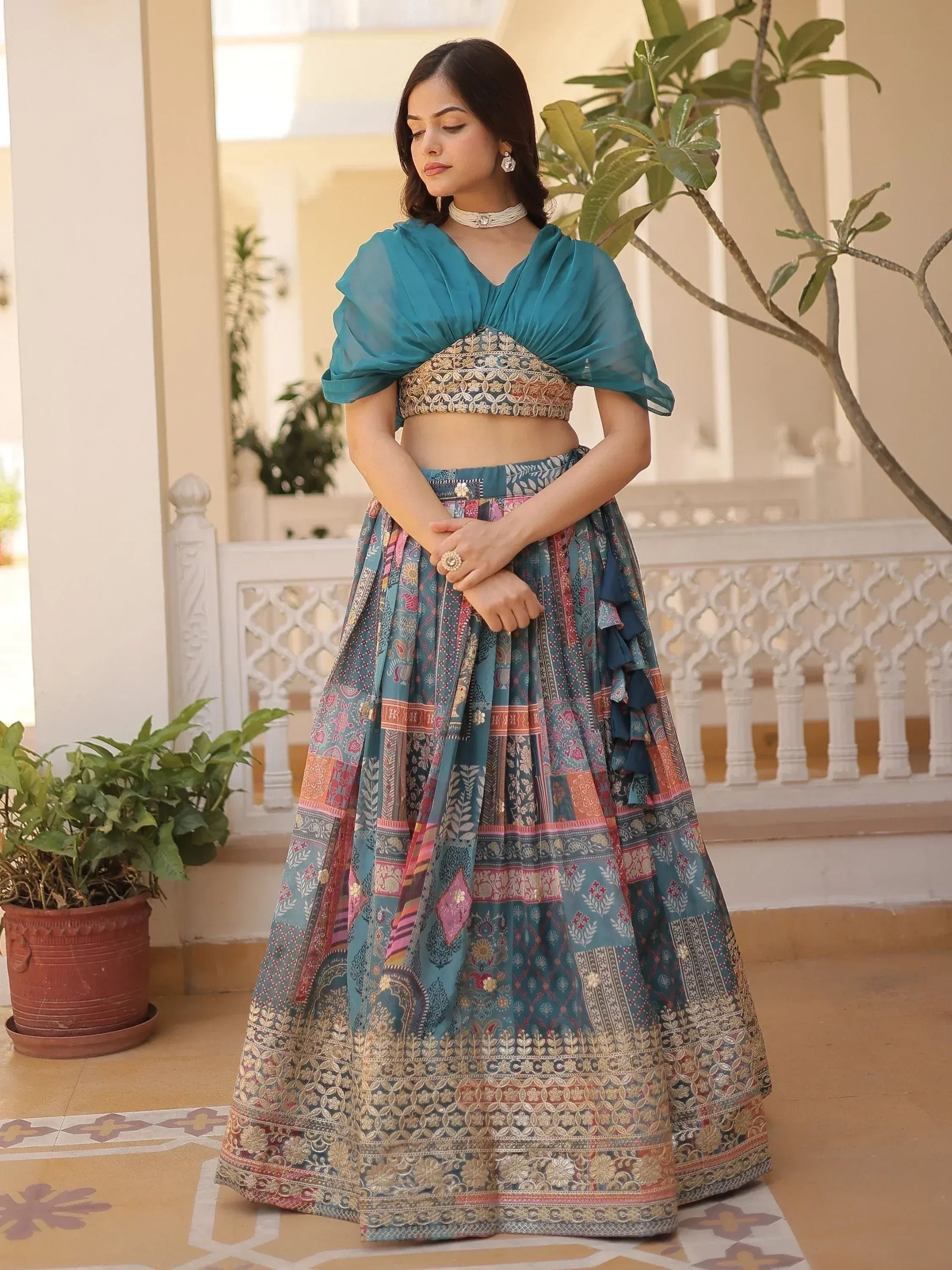 Teal designer lehenga choli with embroidered crop top and printed skirt, perfect for Indian ethnic wear