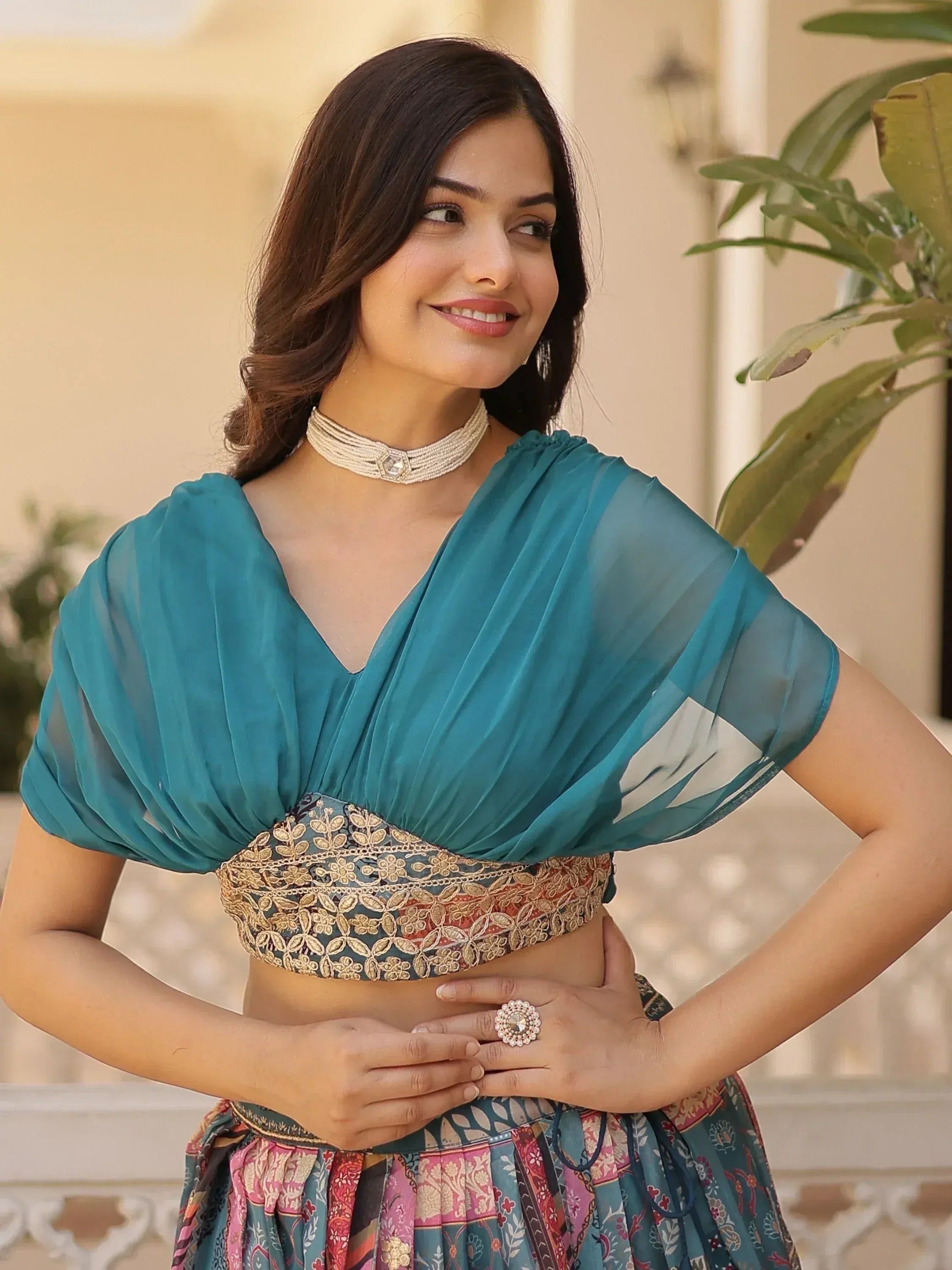 Teal embroidered lehenga choli with sheer puff sleeves, perfect for Indian ethnic wear occasions