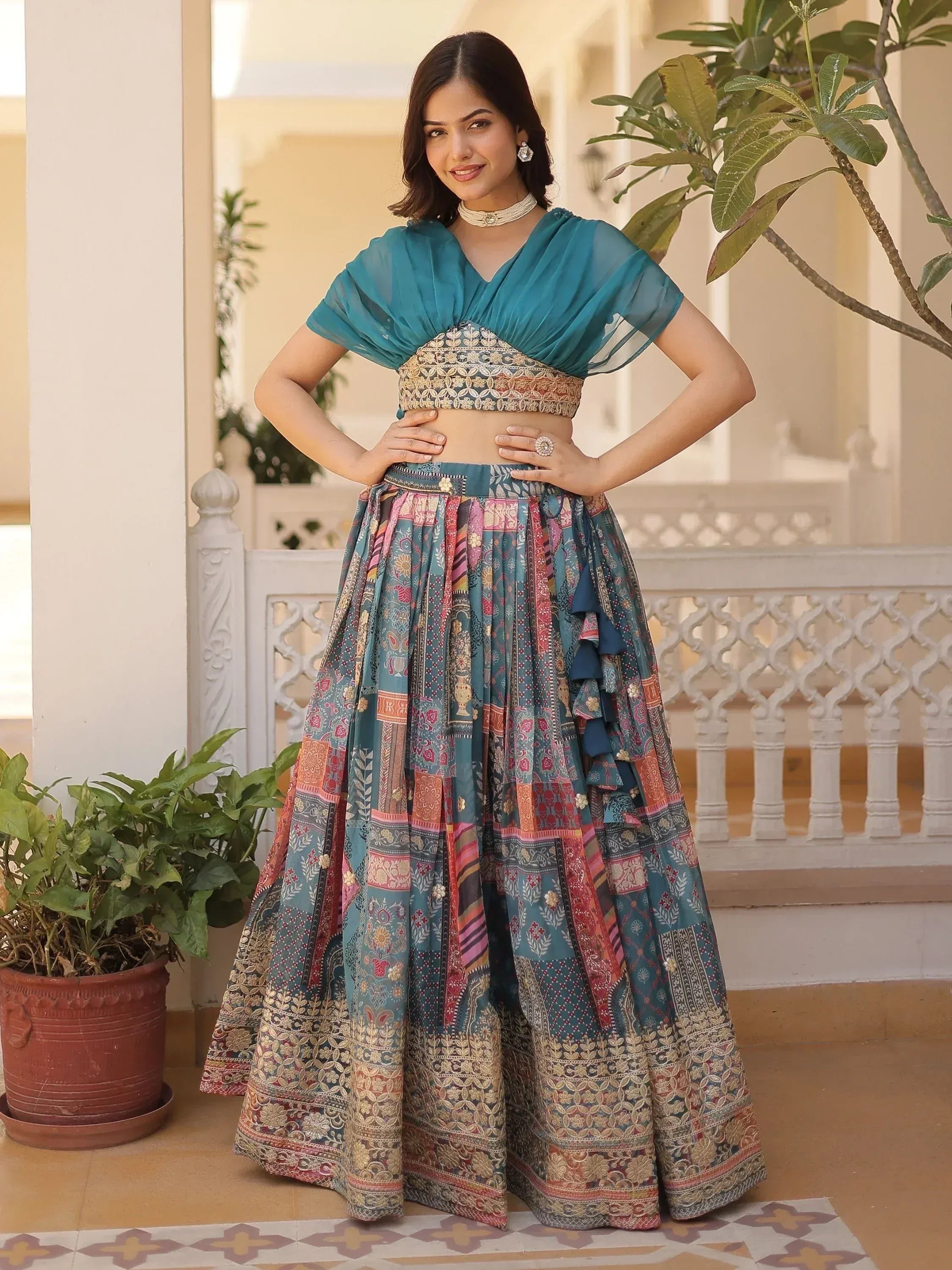 Teal designer lehenga choli with printed skirt and ruffle details, perfect for Indian ethnic wear occasions