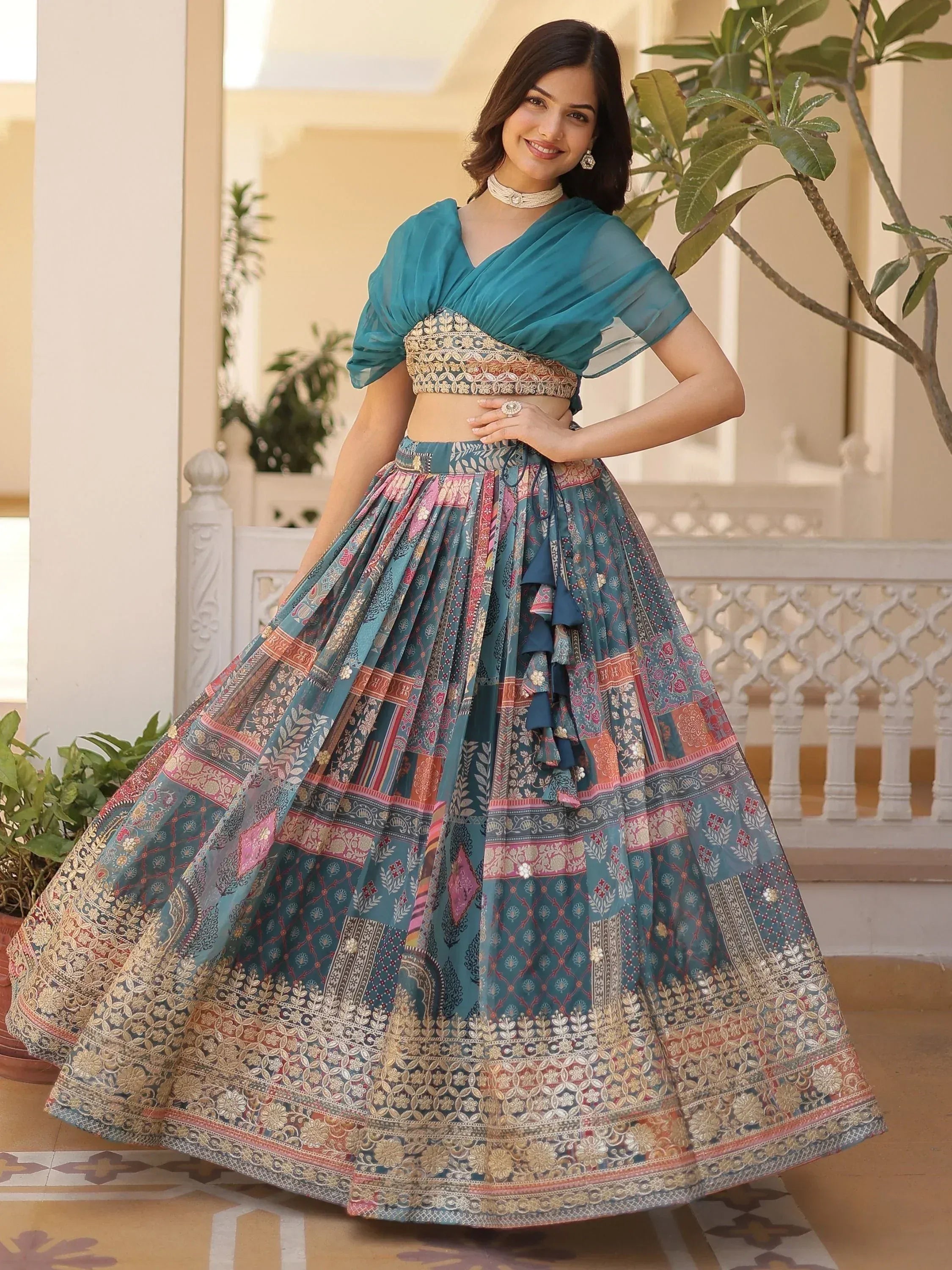 Teal printed lehenga choli with embroidered blouse and ruffled skirt, perfect for Indian ethnic wear occasions