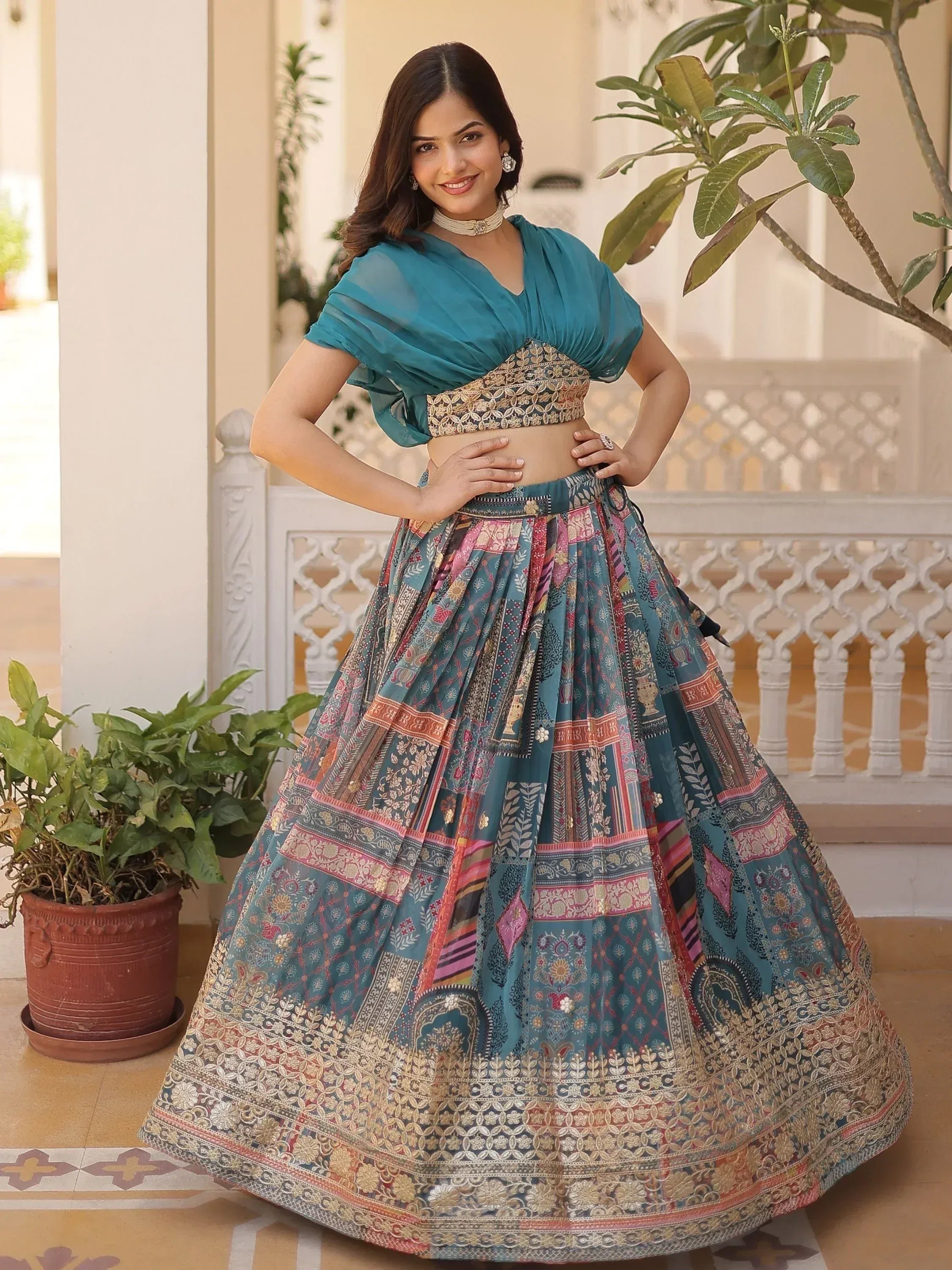Teal designer lehenga choli with printed skirt and embroidered blouse, perfect for Indian ethnic wear occasions