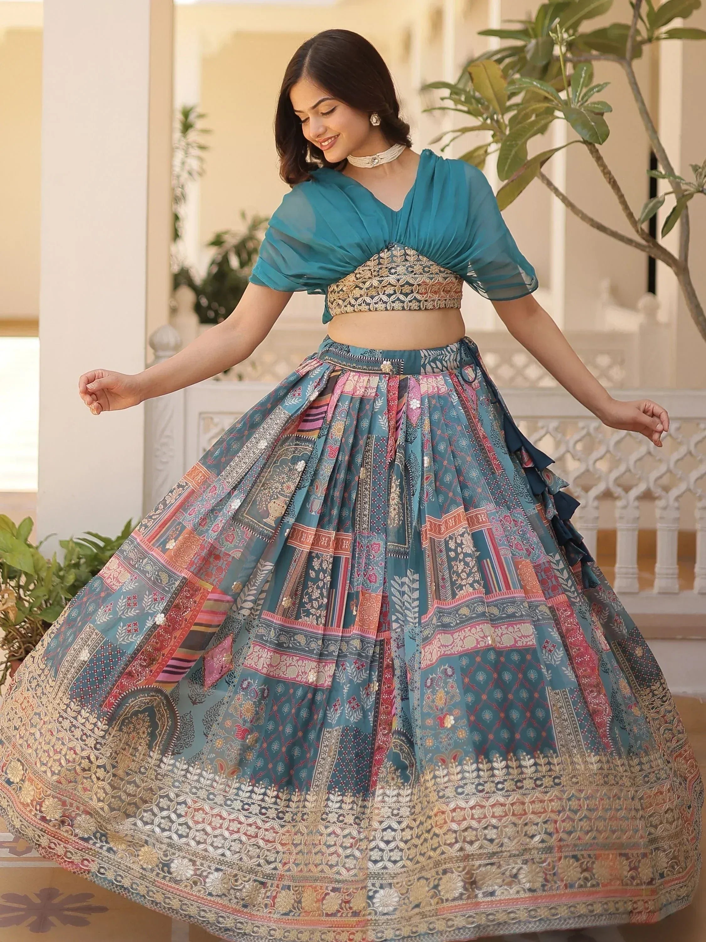 Teal embroidered lehenga choli with patchwork skirt, perfect for Indian ethnic wear and festive occasions.