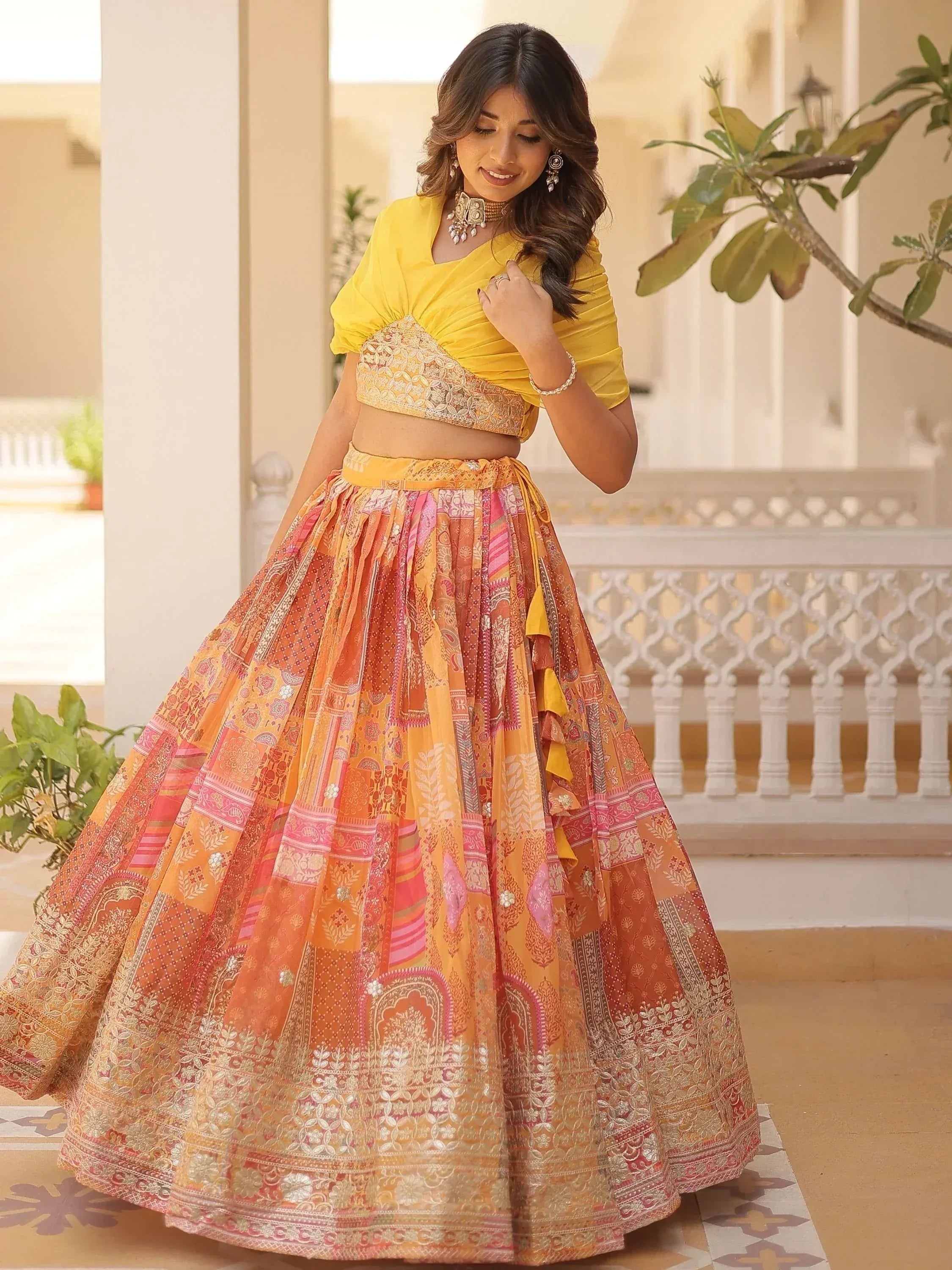 Yellow designer lehenga choli with orange pink patchwork skirt, perfect for Indian ethnic wear occasions