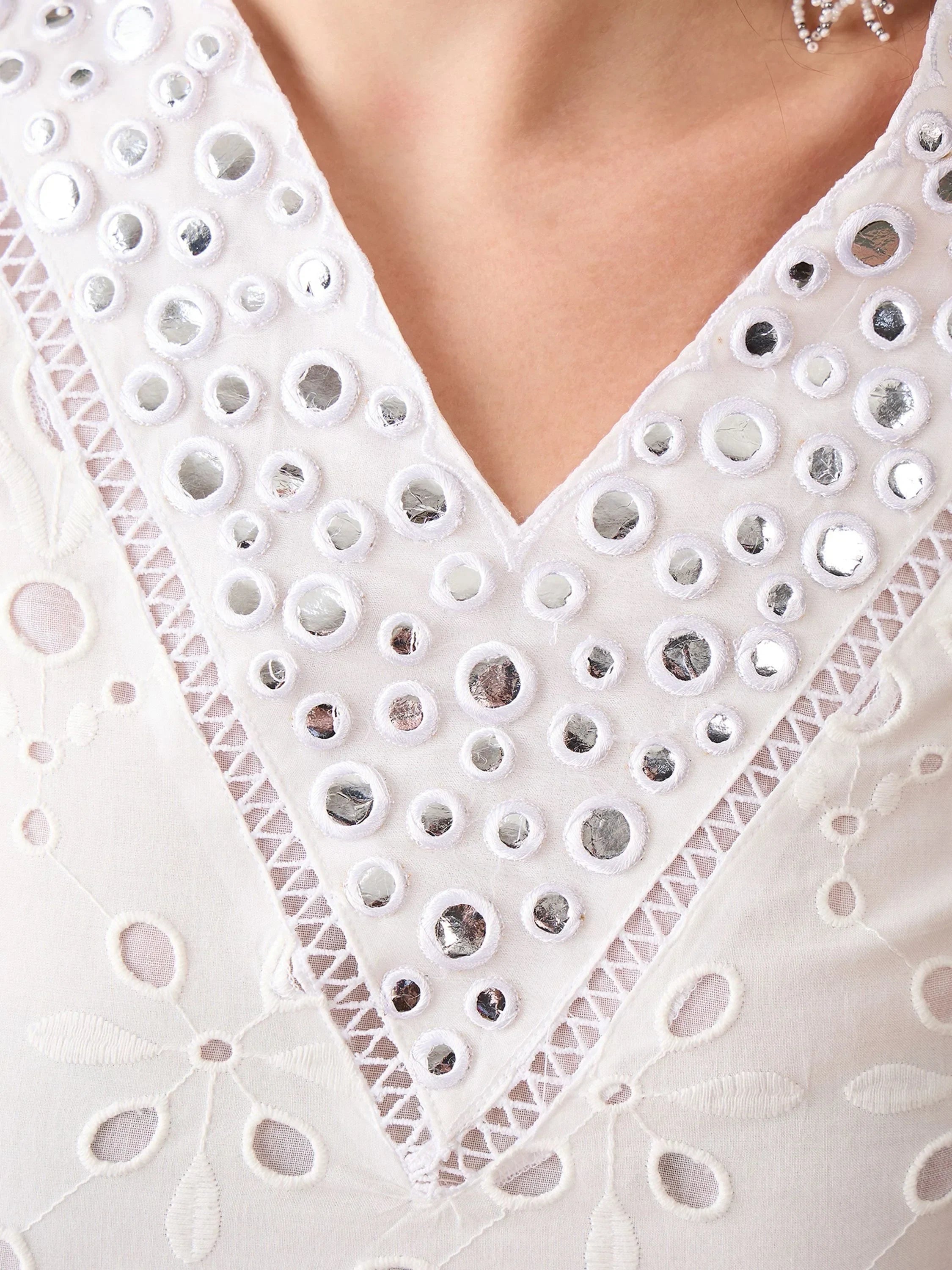 White ethnic kurta with mirror work, floral embroidery, and V-neck design