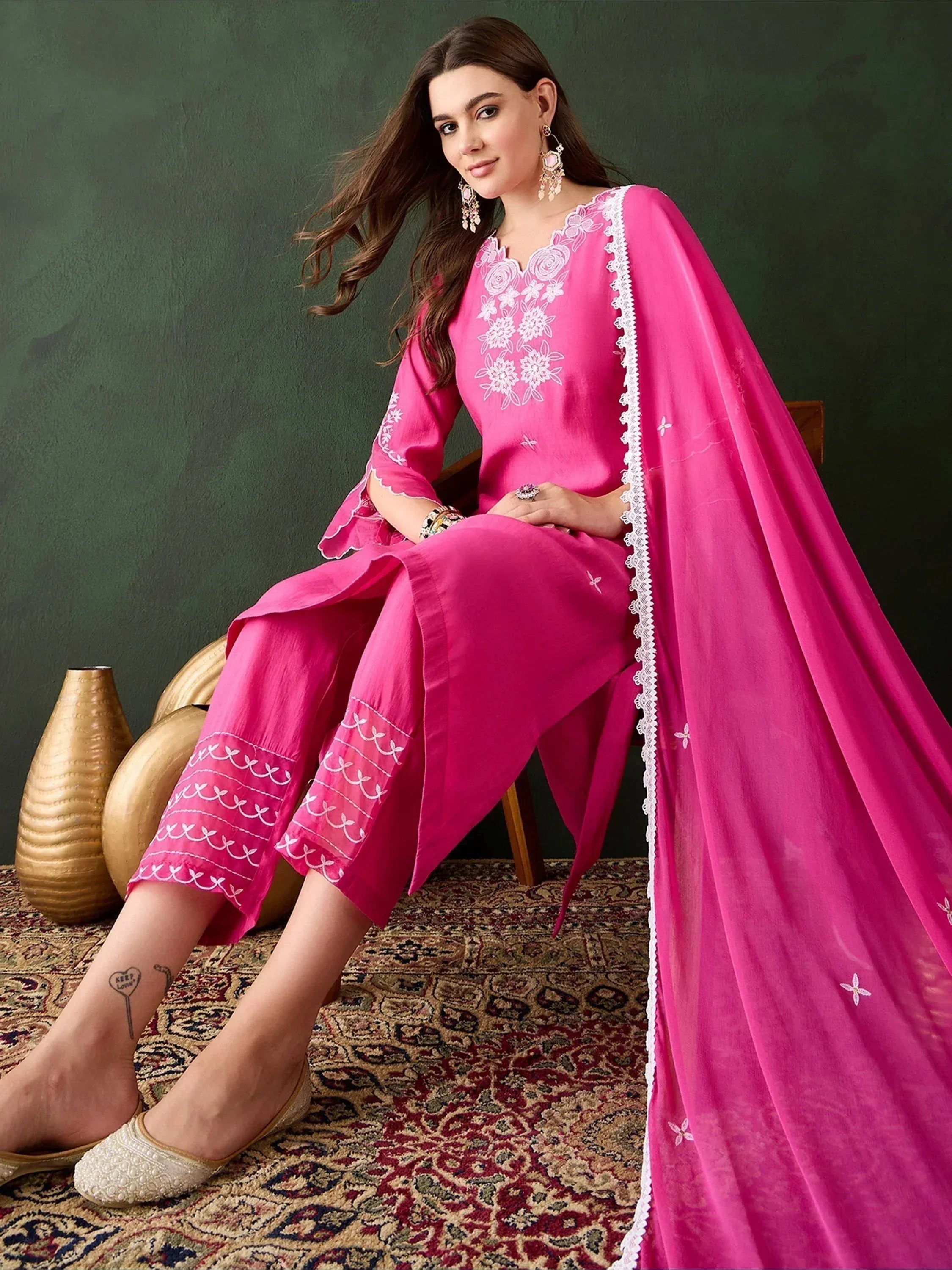 Pink embroidered salwar kameez with white floral detailing, paired with matching dupatta and palazzo pants