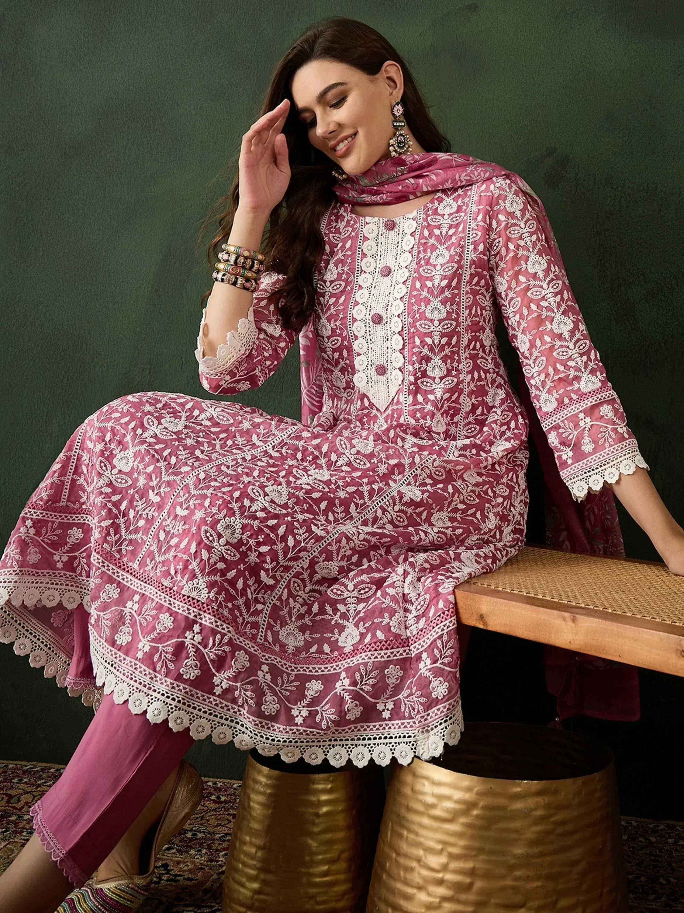 Pink embroidered salwar kameez with white floral work, matching dupatta, and traditional jewelry for ethnic wear