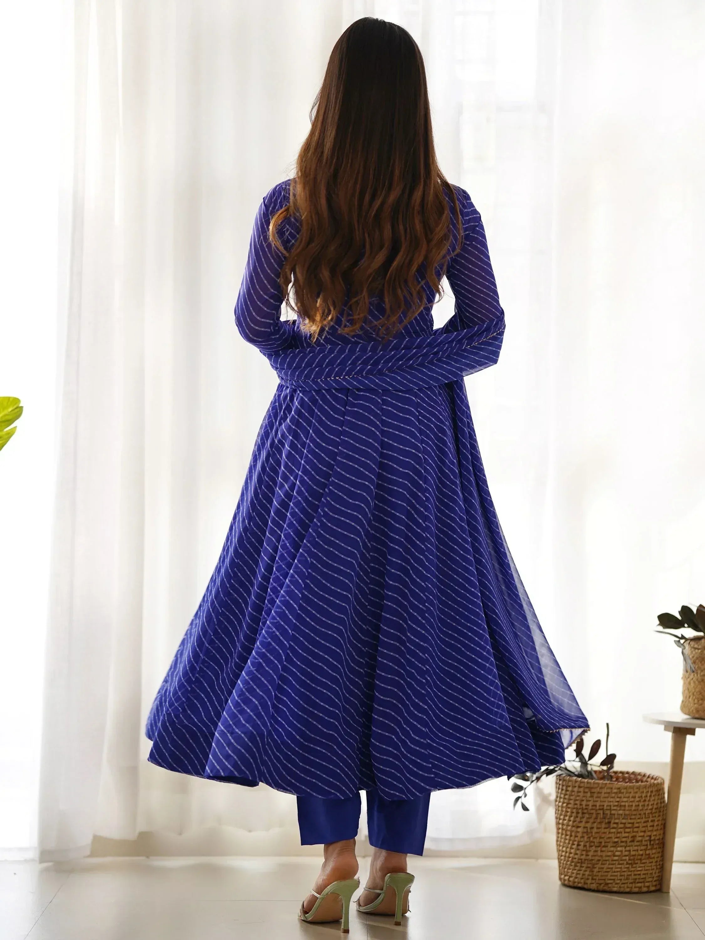 Blue striped ethnic gown with flared skirt and matching pants, back view