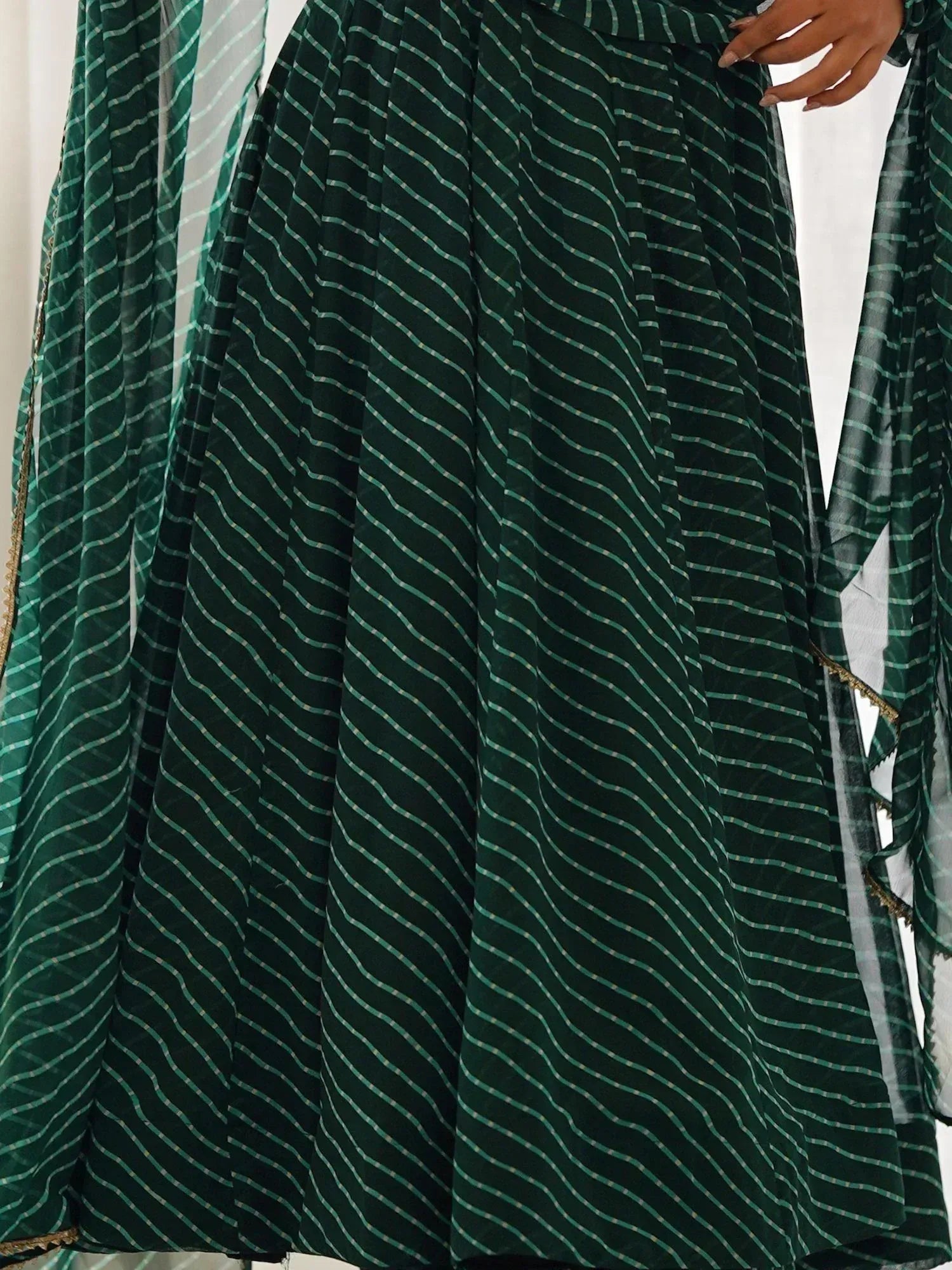 Emerald green striped ethnic lehenga with sheer dupatta, perfect for Indian weddings and festive occasions.