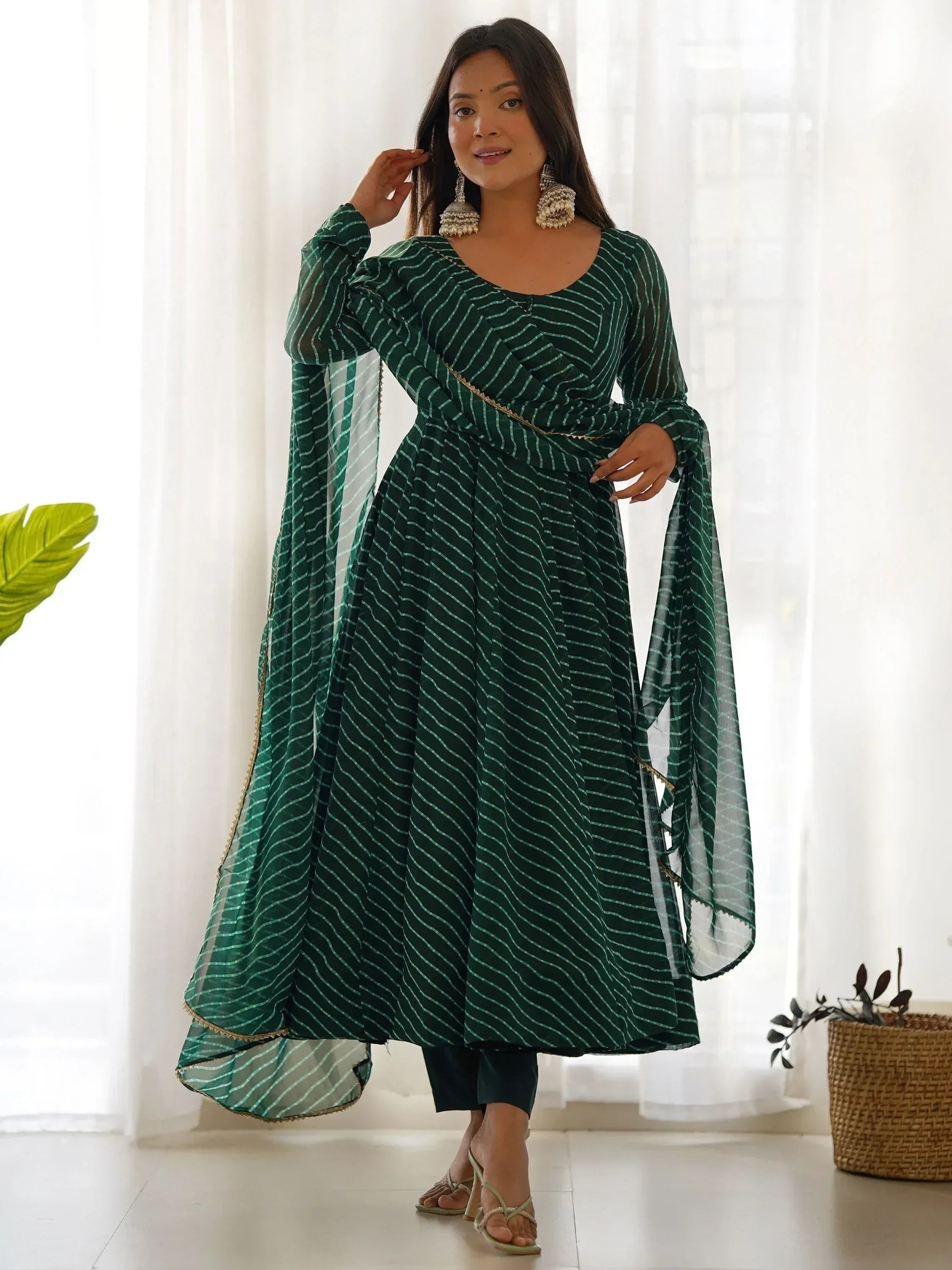 Green striped ethnic anarkali suit with sheer sleeves and gold trim, perfect for Indian occasions