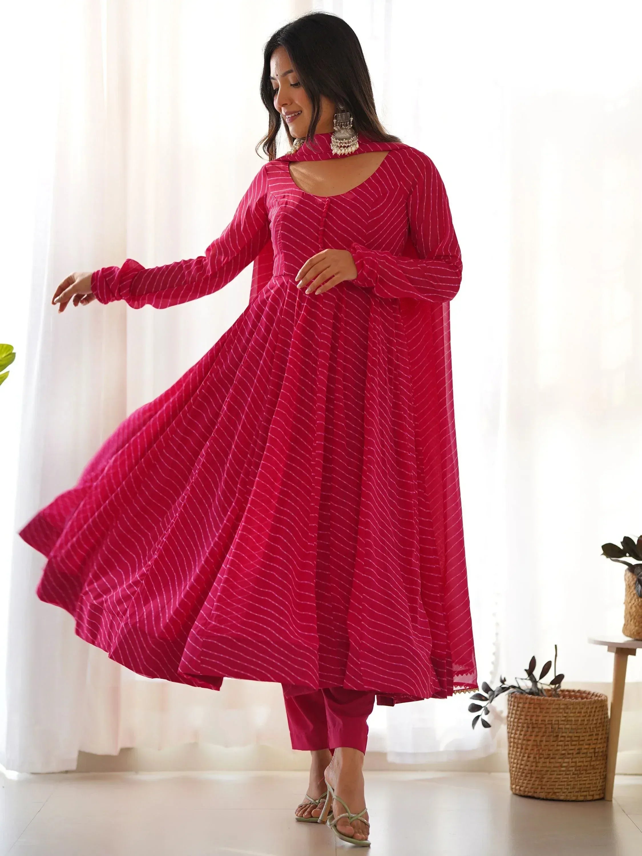 Pink striped ethnic anarkali gown with matching pants, perfect for Indian occasions and festive wear.