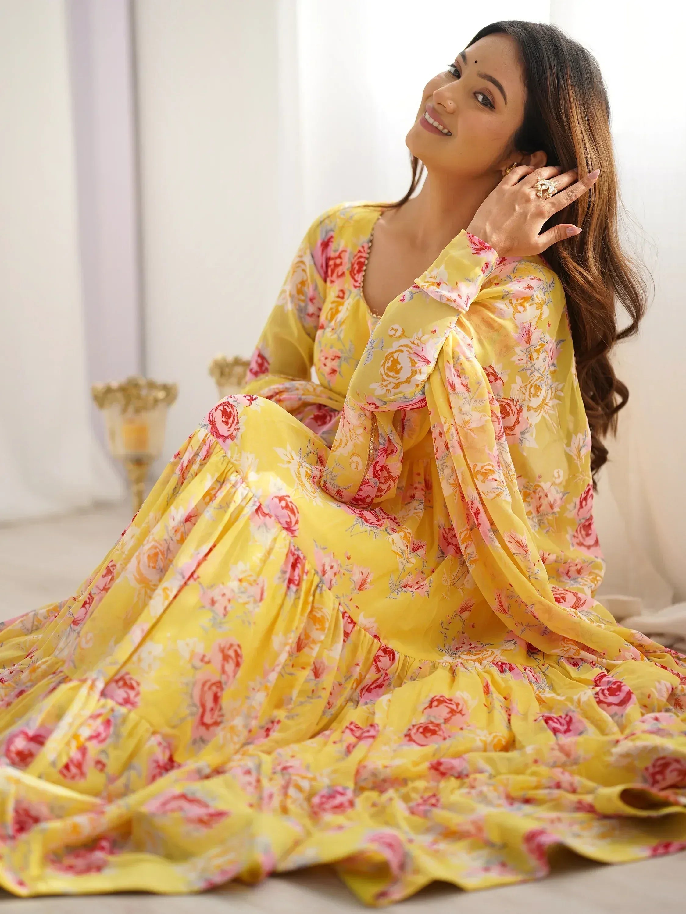 Yellow floral ethnic gown with long sleeves and ruffled hem, perfect for festive occasions