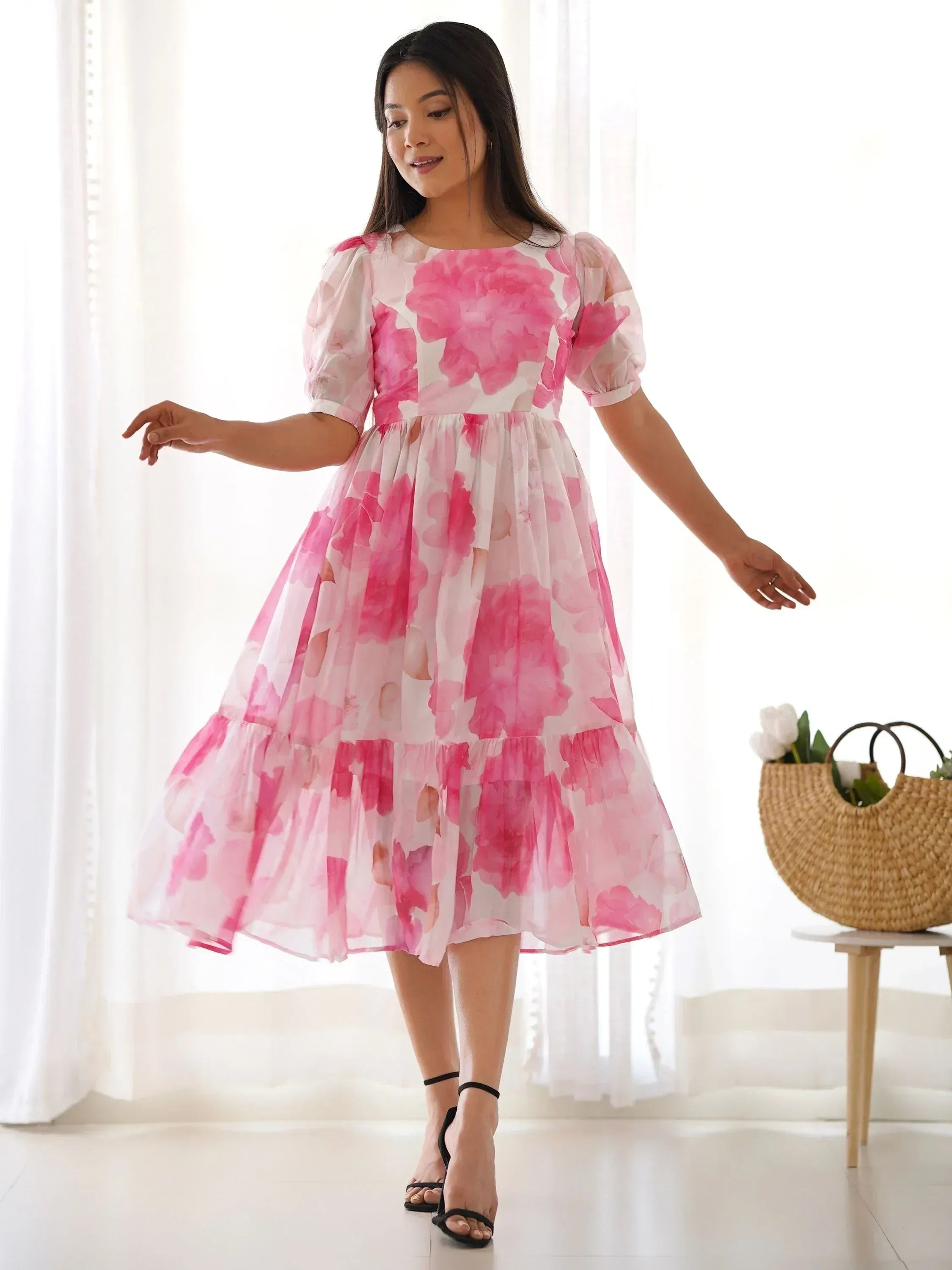 Pink floral print tiered midi dress with puff sleeves, perfect for ethnic occasions and summer events.