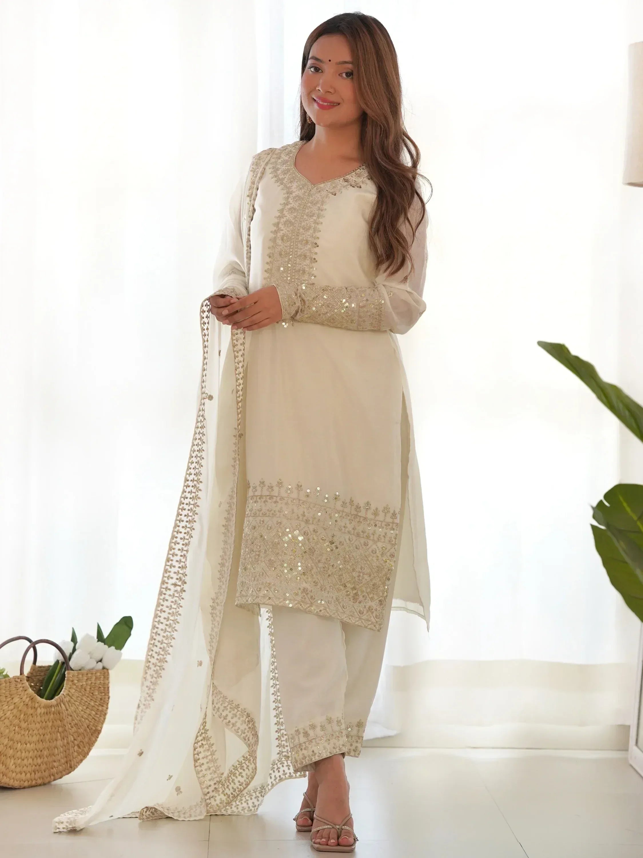 Cream embroidered salwar kameez with sequin work and matching dupatta, ideal for Indian ethnic wear
