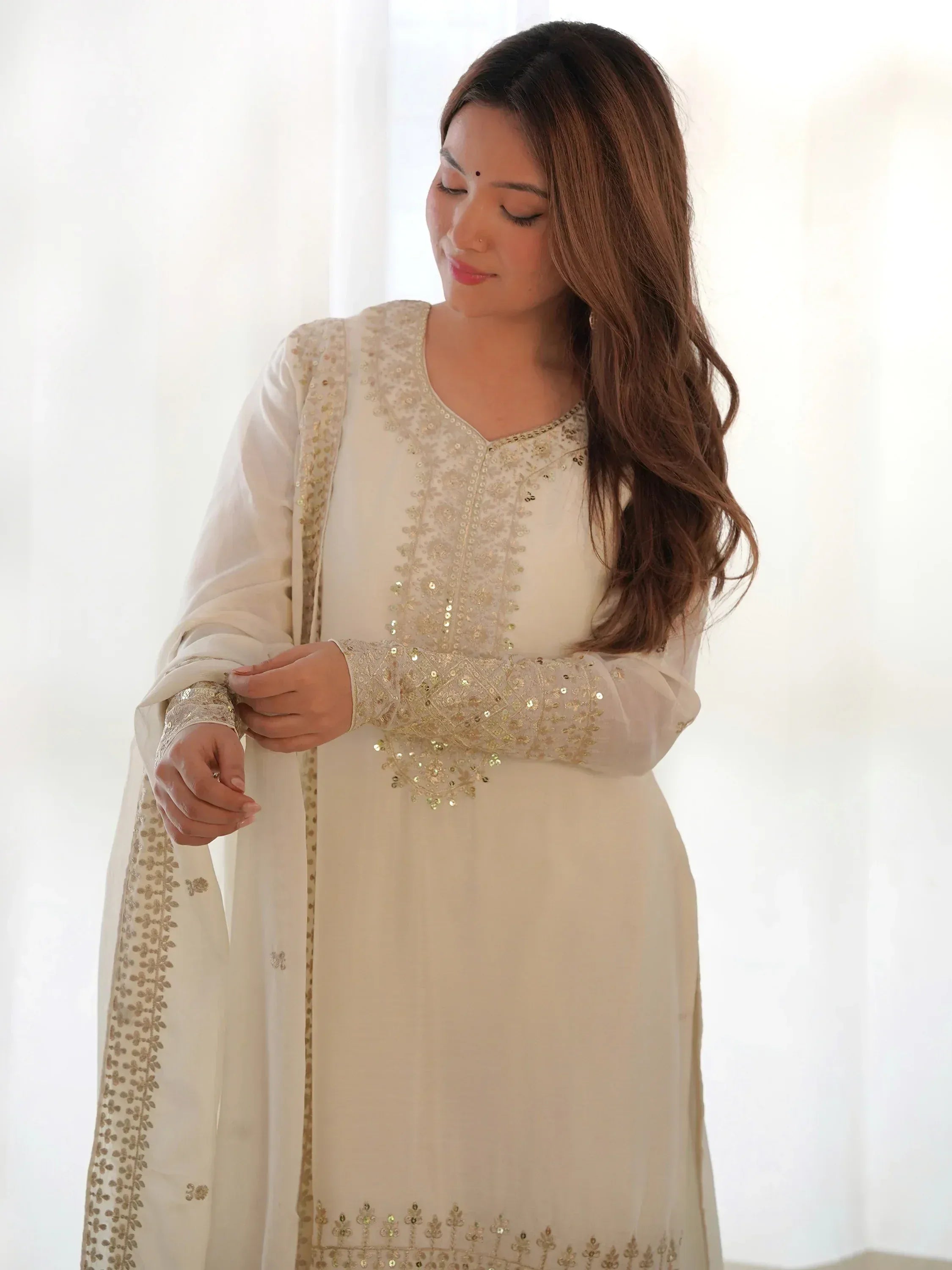 Elegant white ethnic kurti with gold embroidery and sequins, perfect for Indian festive wear
