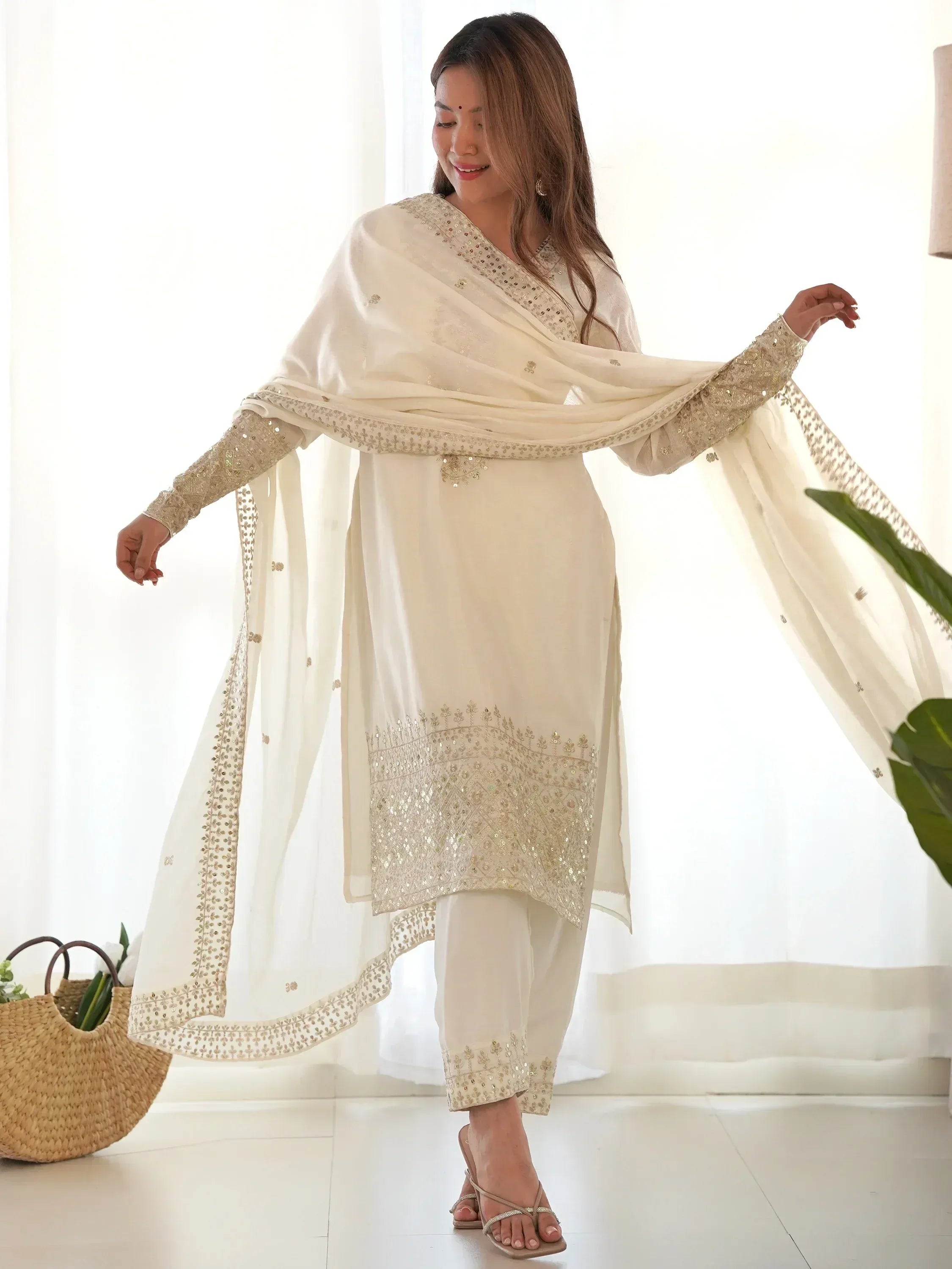 Elegant ivory salwar kameez with gold embroidery and matching dupatta, perfect for Indian ethnic occasions.