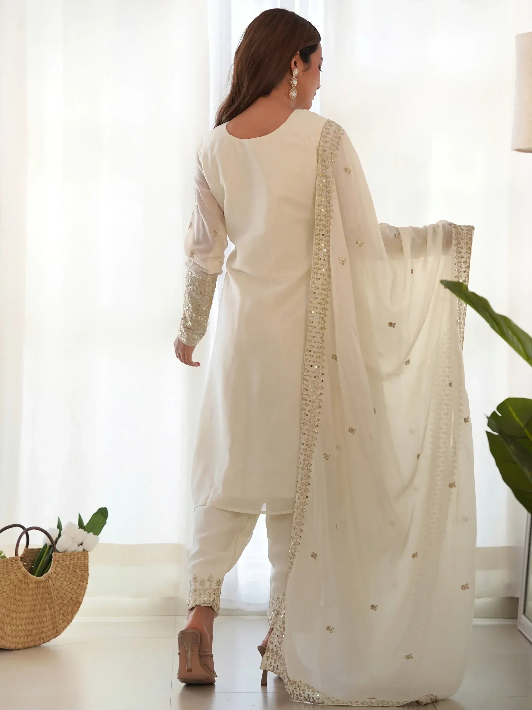 Elegant ivory salwar kameez with gold embroidery, sheer dupatta, and matching pants for Indian ethnic wear