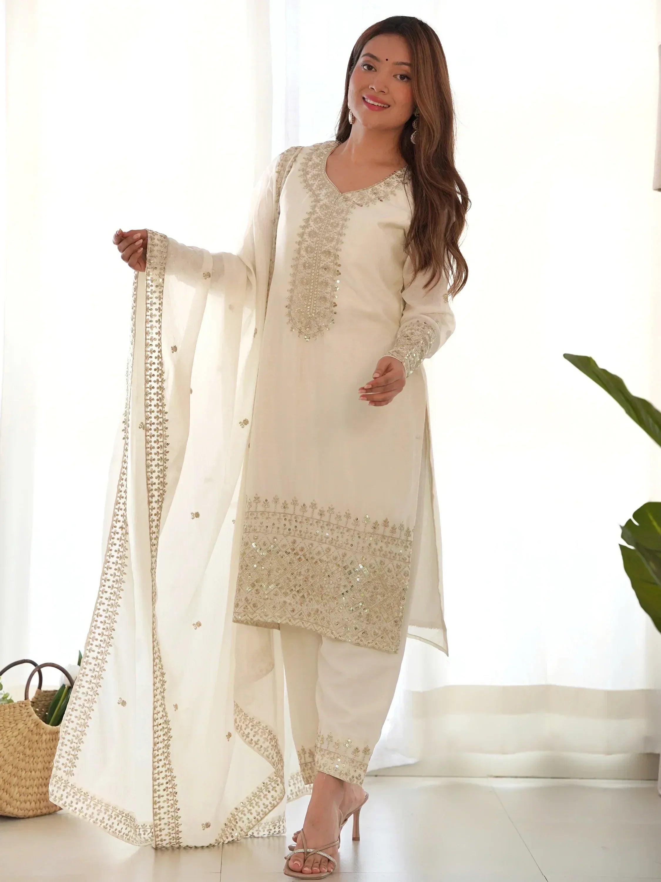 Elegant ivory salwar kameez with gold embroidery and sequin work, perfect for Indian ethnic occasions.