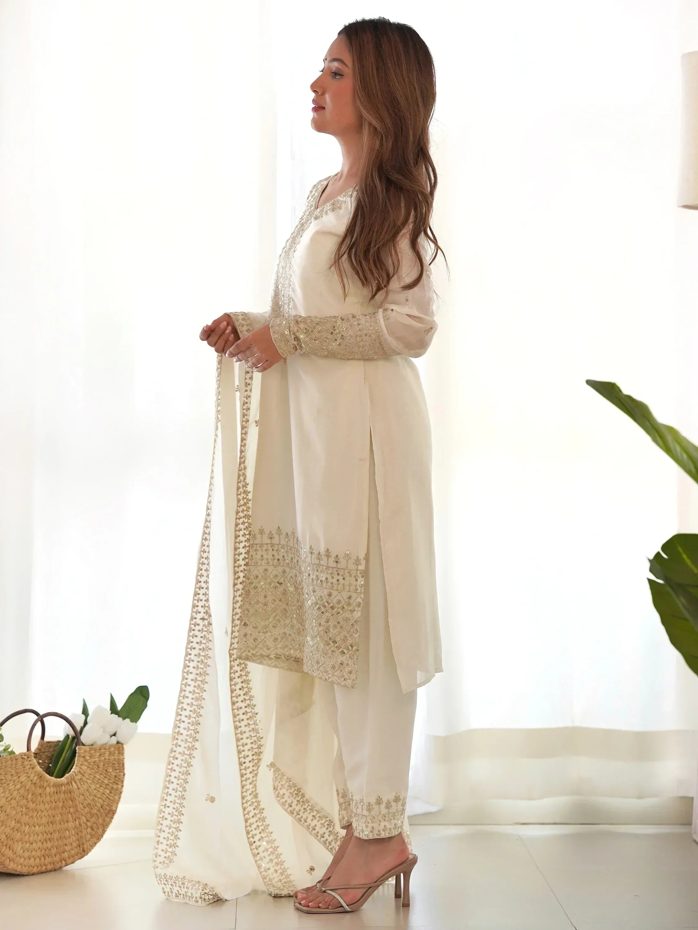 Elegant ivory salwar kameez with gold embroidery, perfect for Indian ethnic wear occasions.