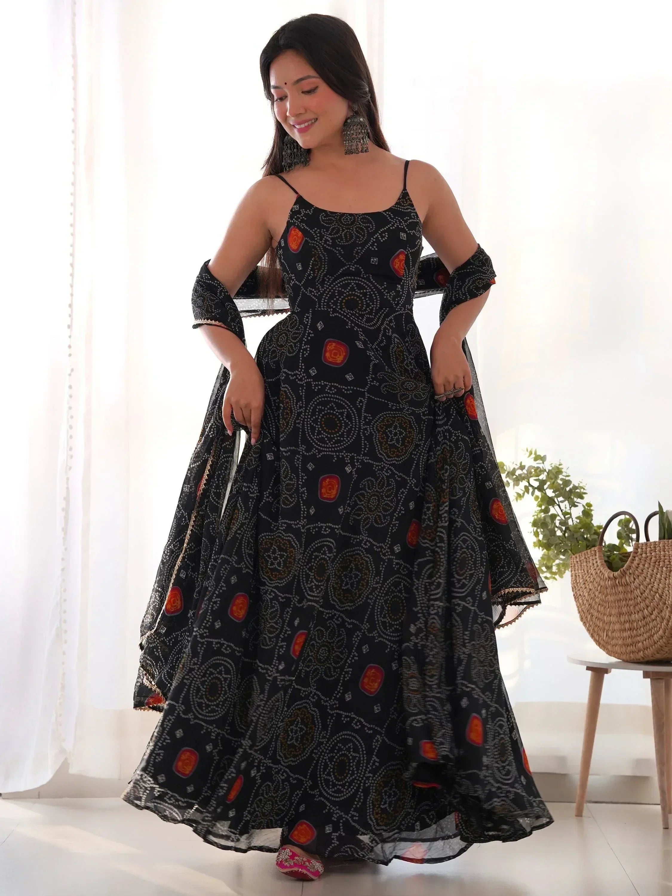 Black printed ethnic gown with spaghetti straps and flared skirt, perfect for Indian occasions