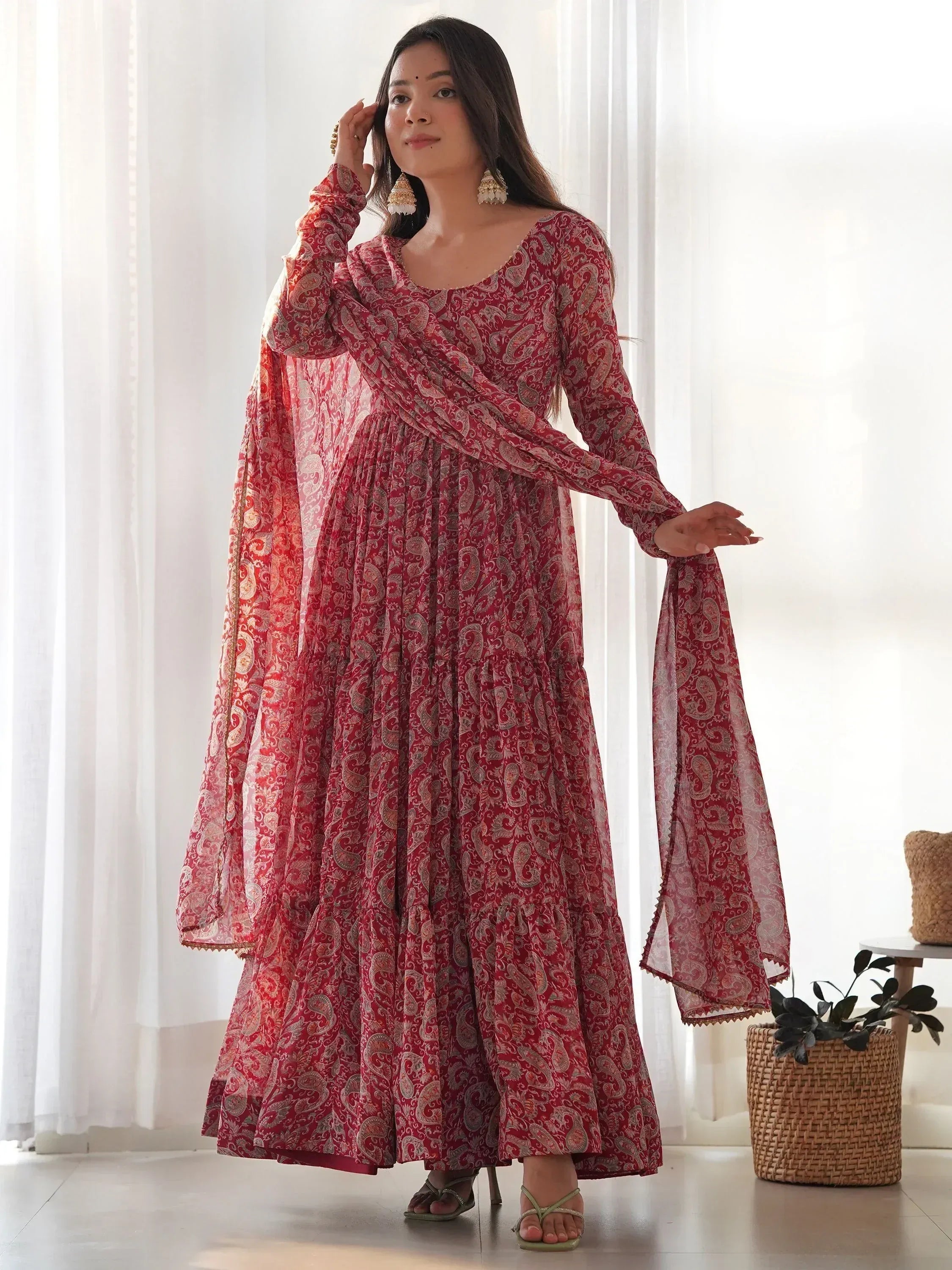 Red paisley print ethnic gown with flared sleeves and matching dupatta, styled for Indian occasions