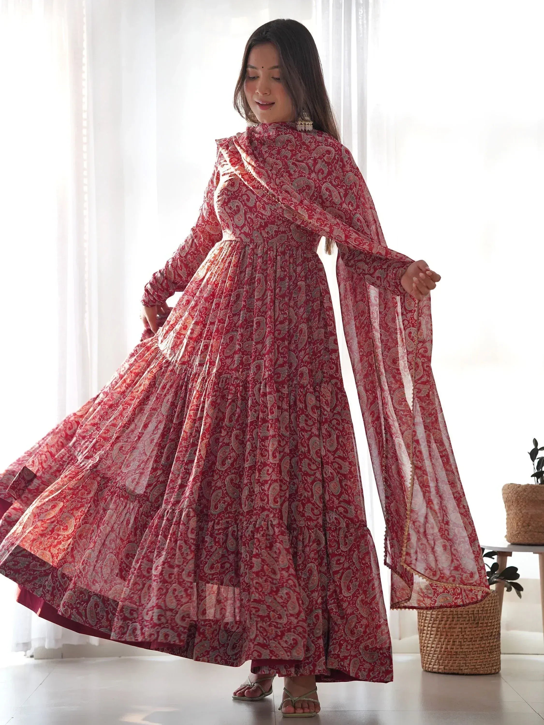 Red paisley print ethnic gown with flared skirt and matching dupatta, perfect for Indian occasions