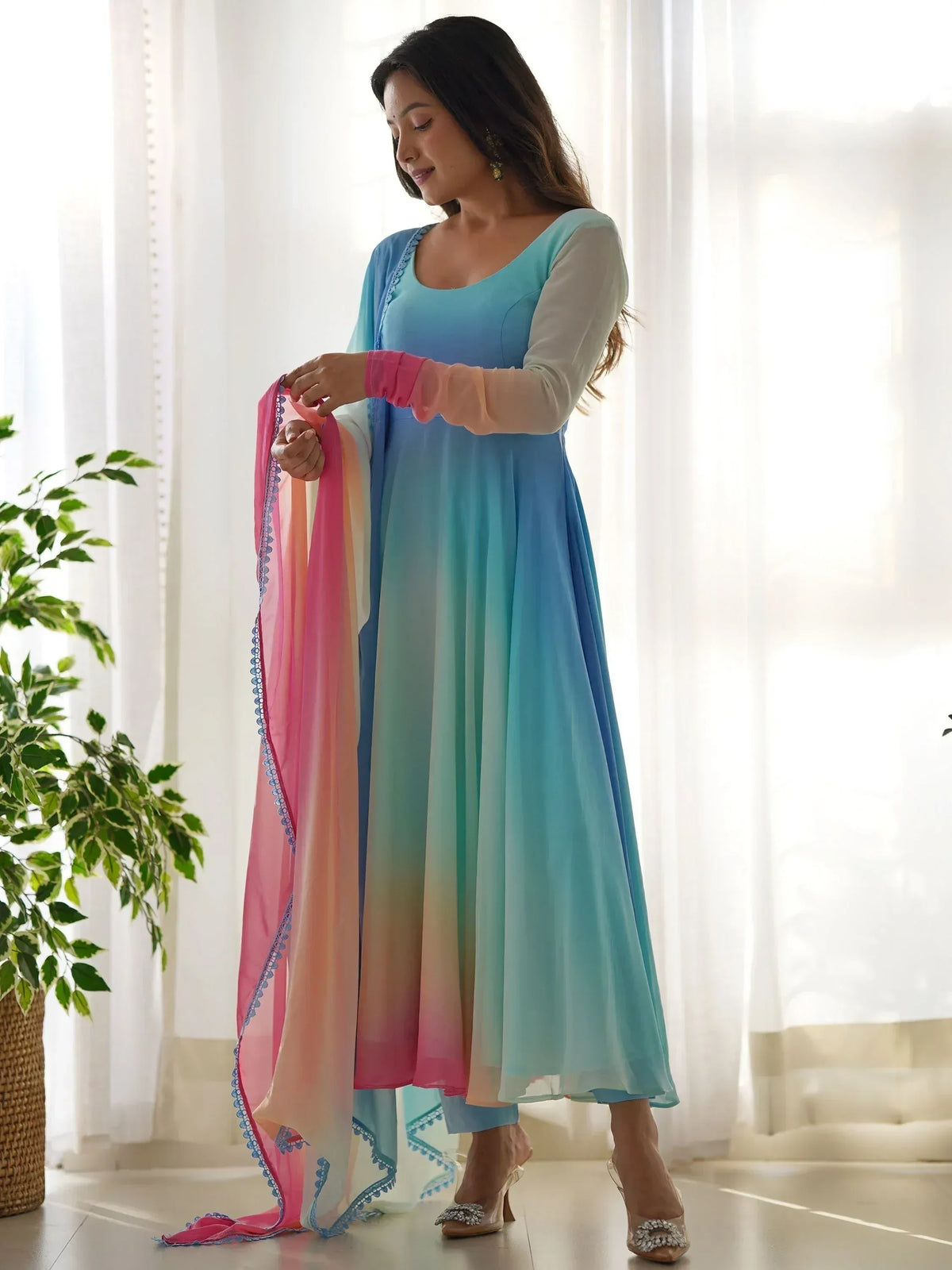 Woman in blue ombre ethnic gown with pink dupatta, stylish Indian wear for festive occasions