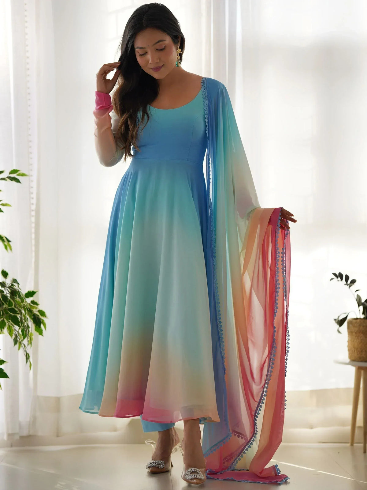Woman in gradient blue to pink ethnic anarkali gown with matching dupatta, perfect for Indian festive occasions