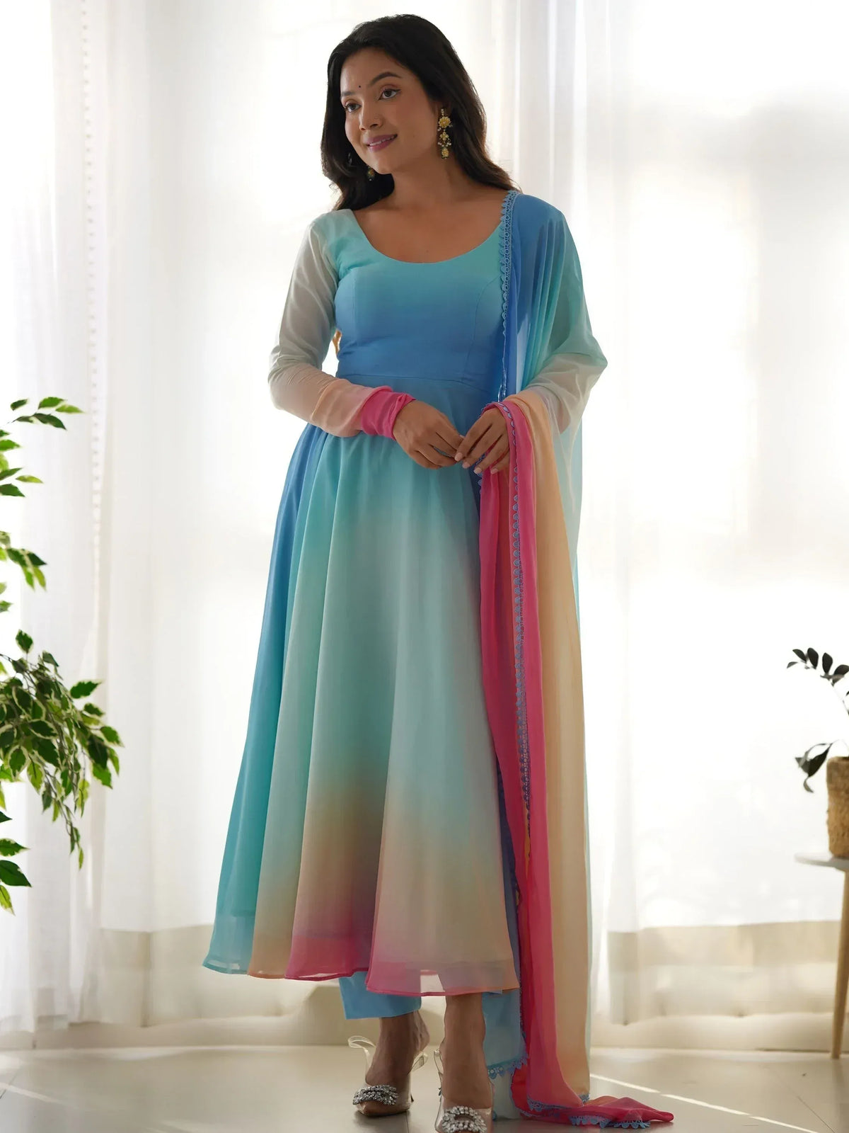 Woman in ombre blue to pink Indian anarkali suit with matching dupatta, perfect for ethnic occasions