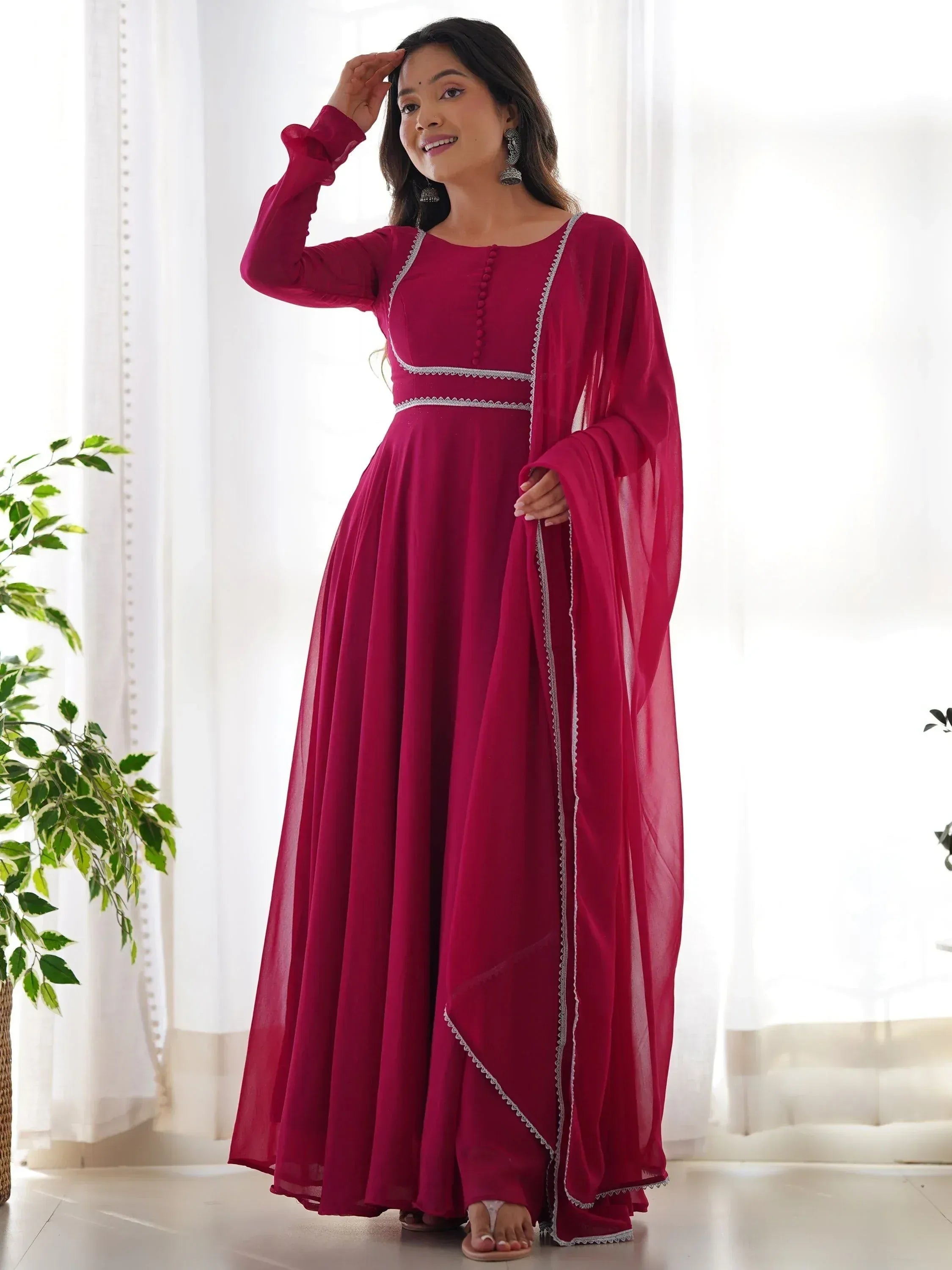 Woman in maroon ethnic gown with silver trim, perfect for Indian occasions and festive wear
