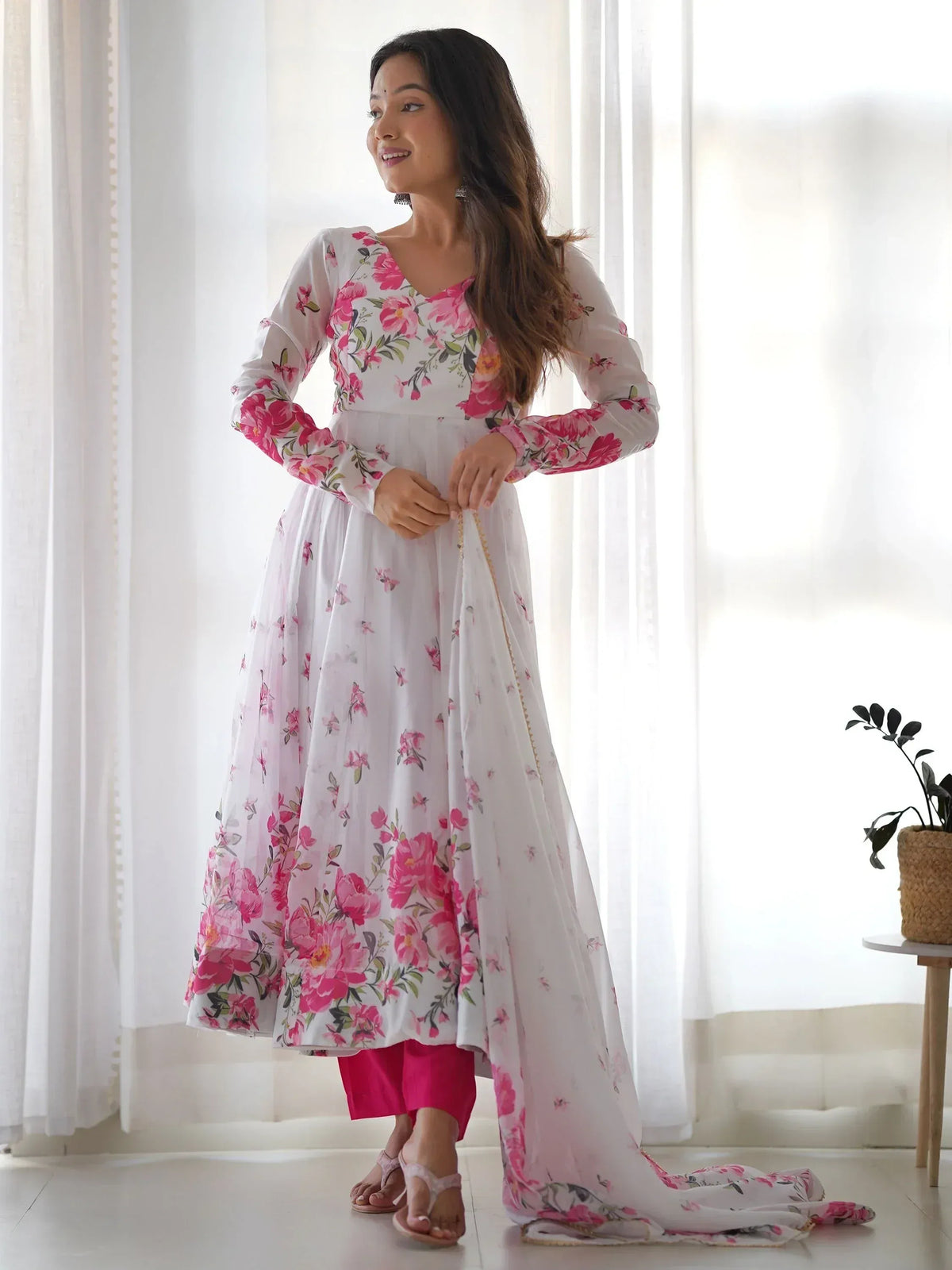 White floral anarkali with pink print, paired with matching pants and dupatta, ideal for ethnic occasions.