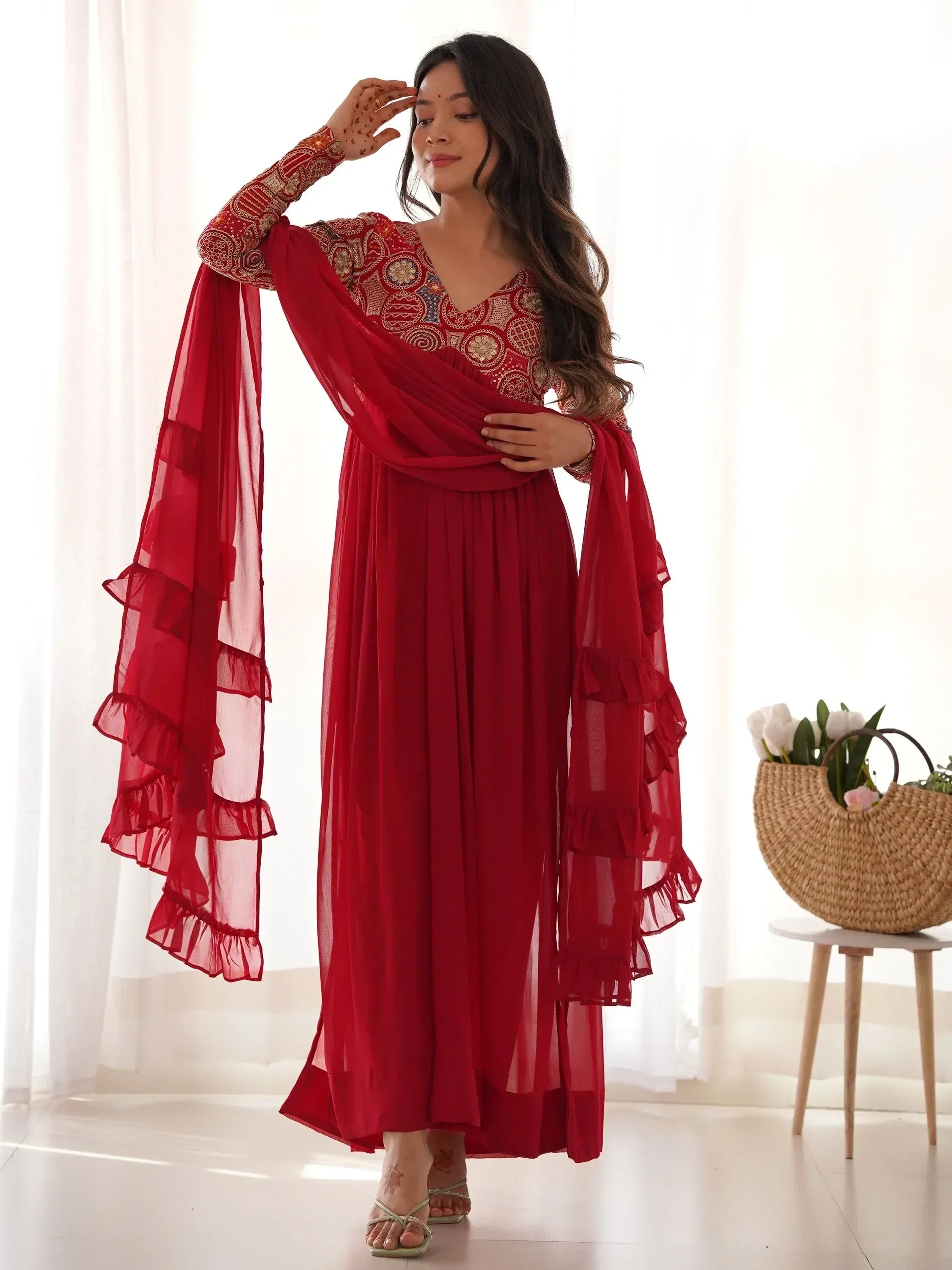 Red ethnic gown with embroidered bodice and ruffled dupatta, perfect for Indian occasions