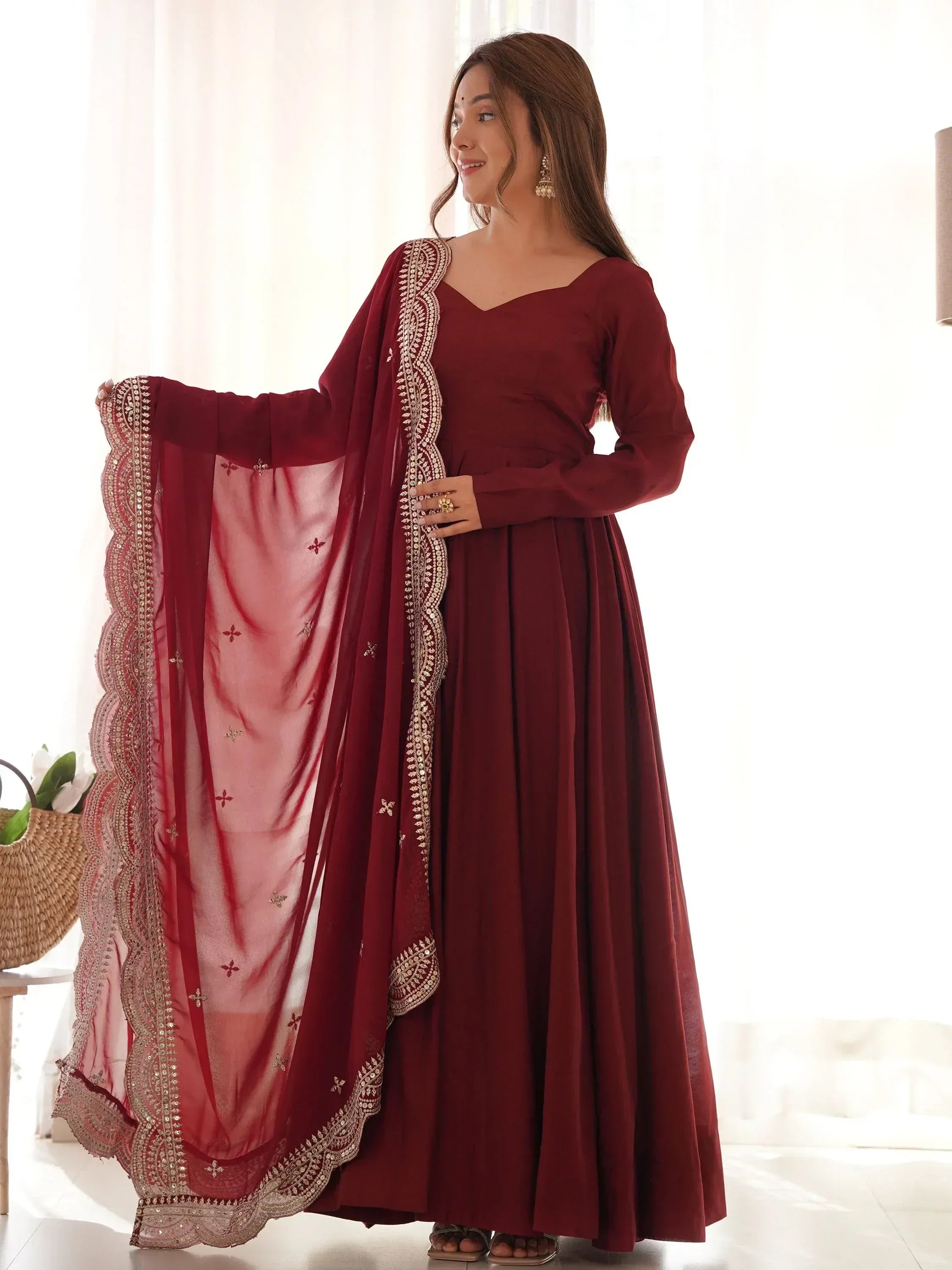 Maroon ethnic gown with gold embroidery and matching dupatta, perfect for Indian occasions