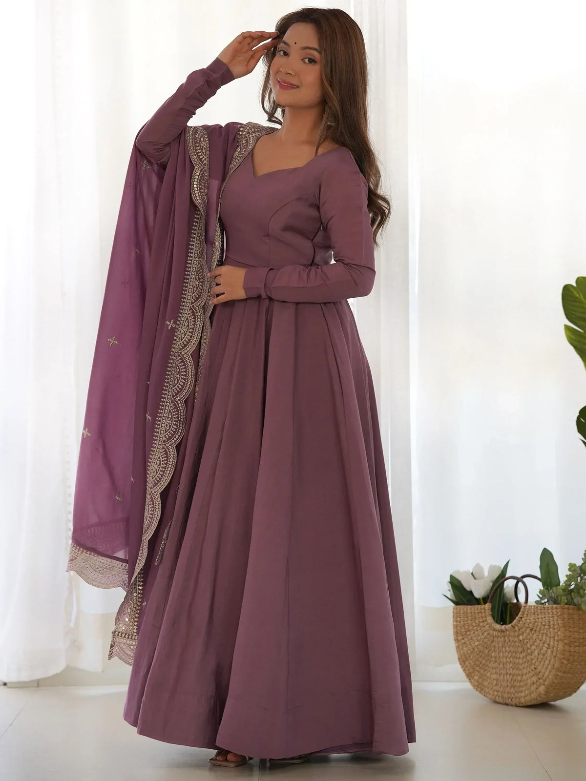 Elegant mauve ethnic gown with gold embroidery, perfect for Indian festive occasions and weddings.