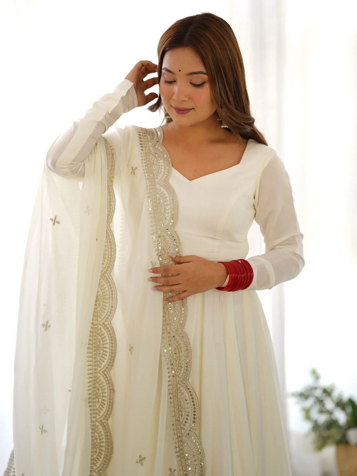 White ethnic gown with gold embroidery, perfect for Indian occasions and festive wear