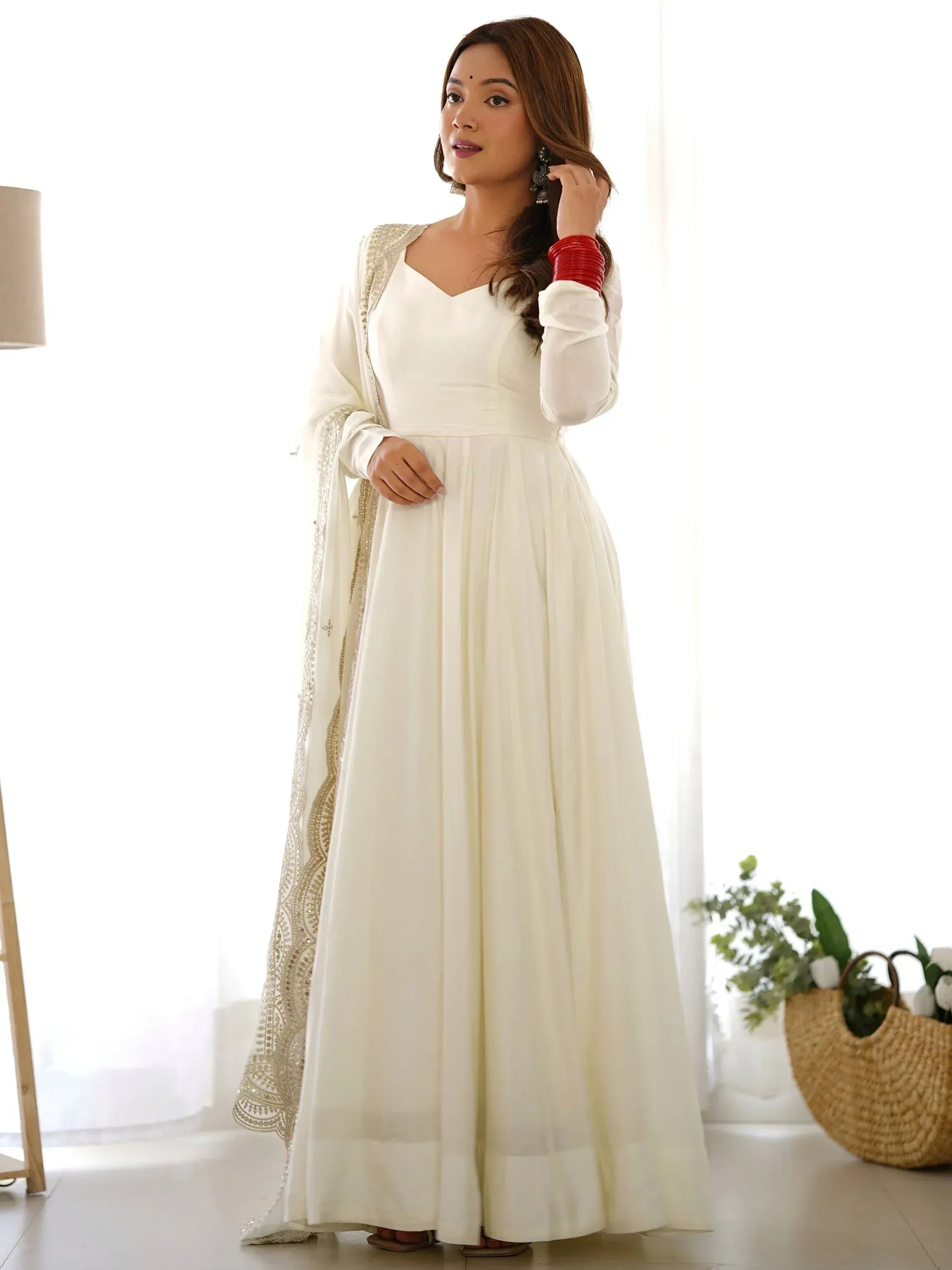 White ethnic gown with gold embroidery, perfect for Indian occasions and festive wear