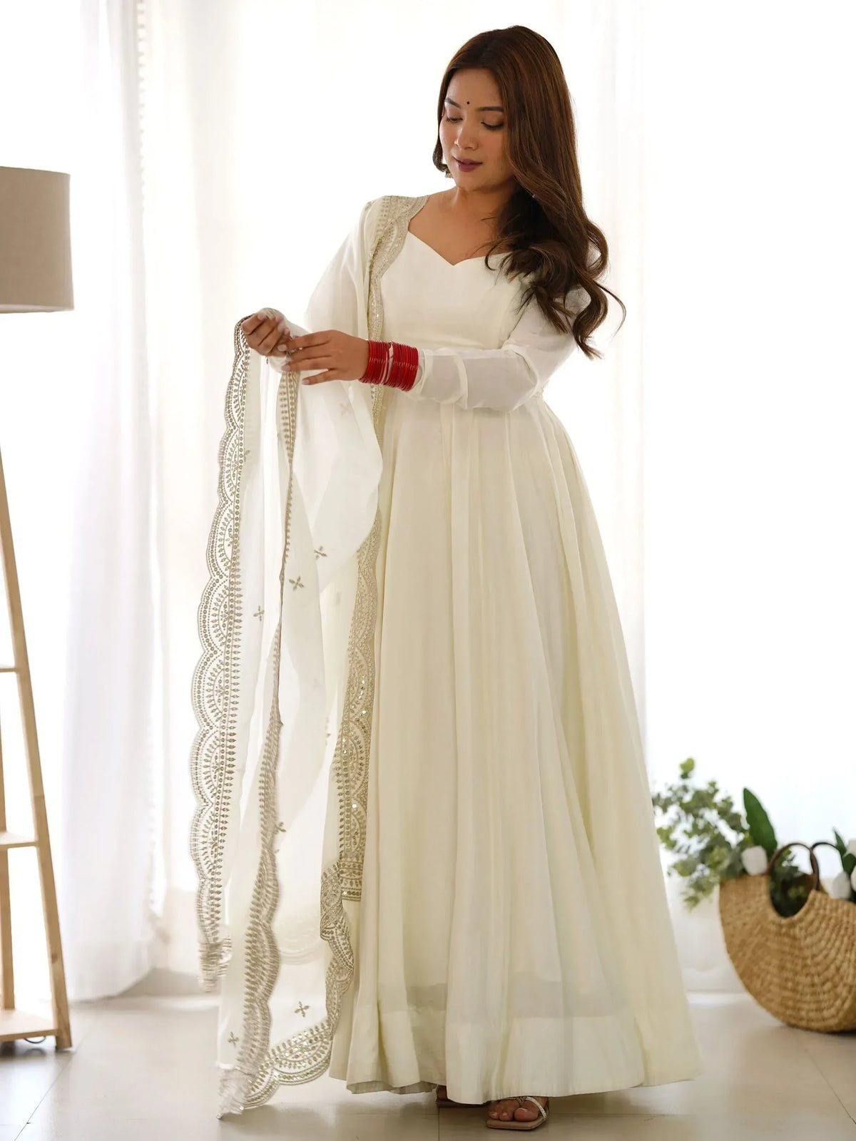 White ethnic anarkali gown with gold embroidery and dupatta, perfect for Indian occasions