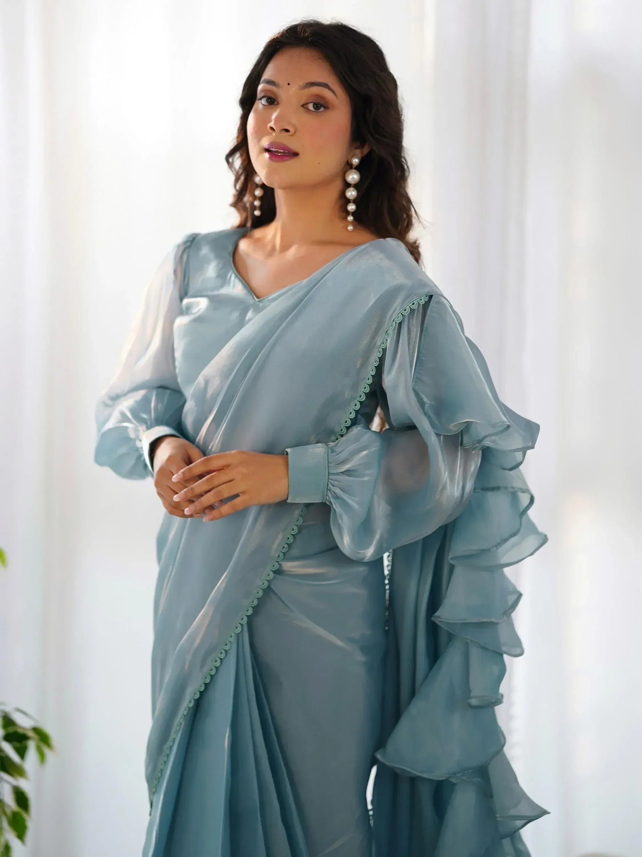 Light blue ethnic gown with ruffled sleeves and scalloped detailing, perfect for Indian occasions